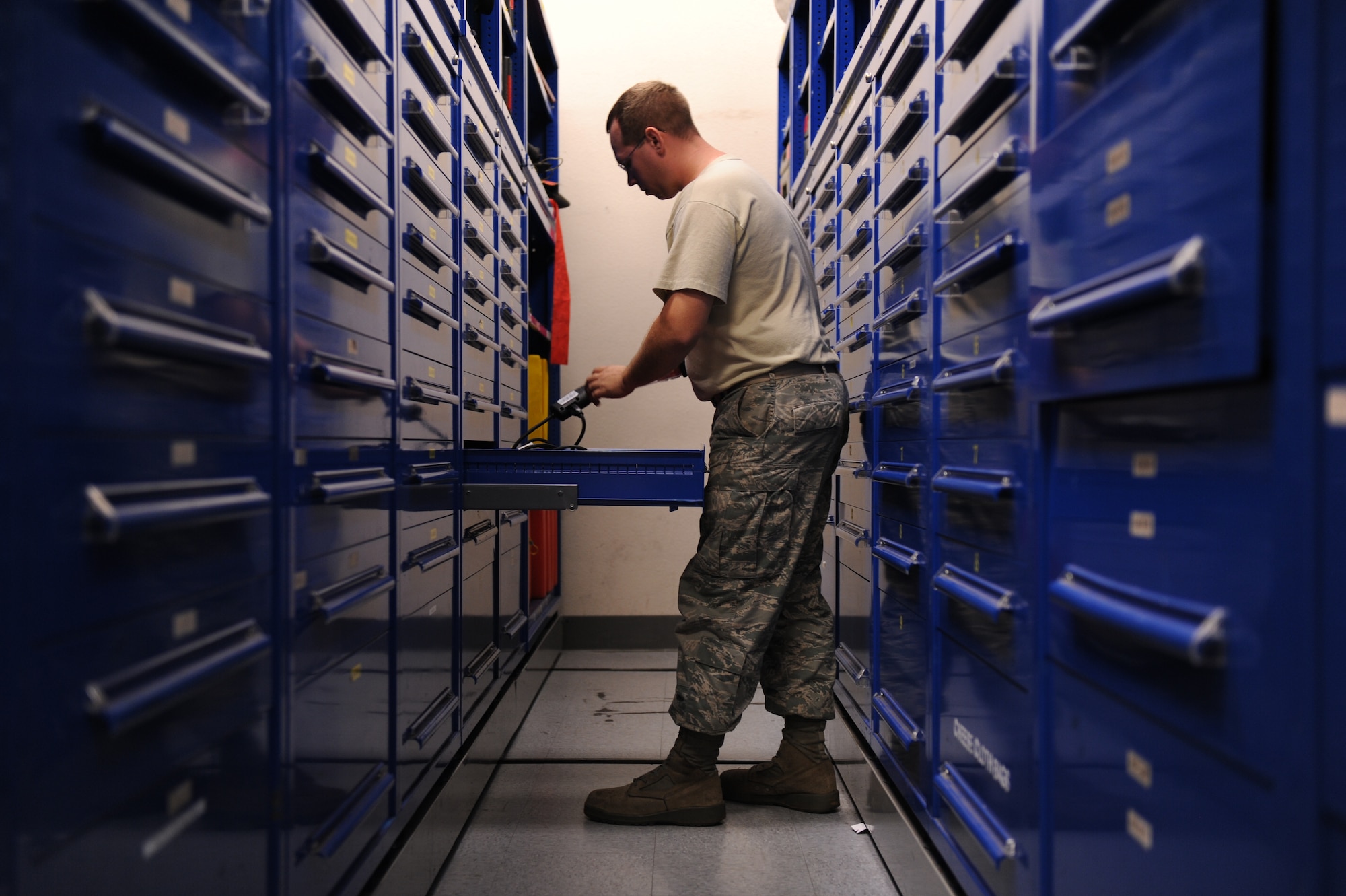 JOINT BASE PEARL HARBOR-HICKAM, Hawaii - Staff Sgt. Robert Wilson, 735th Air Mobility Squadron consolidated tool kit technician, reaches for a tool at the joint consolidated tool kit here, Oct. 22.The consolidated tool kit is a tool shop made up of 15th Aircraft Maintenance Squadron and 735th Air Mobility Squadron consolidated tool kit Airmen. (U.S. photo/Senior Airman Gustavo Gonzalez)
