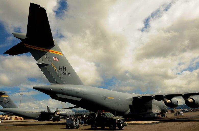 JOINT BASE PEARL HARBOR-HICKAM, Hawaii -- Airmen work to load a C-17 Globemaster III during Beverly Kahuna 2010-F, an Initial Response Readiness Exercise Oct. 20-21. During the exercise, more than 200 Airmen were processed through a deployment line, eight C-17 missions were generated and 140 short tons of cargo was moved while practicing the "deployment machine." This exercise concentrated on the basic "blocking and tackling" of getting cargo and people downrange. (U.S. Air Force photo/Staff Sgt. Mike Meares) 