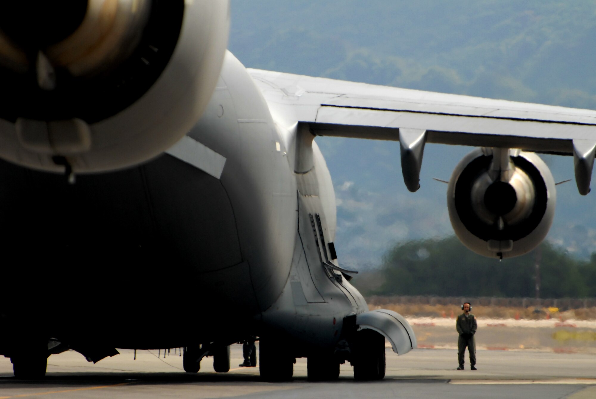 JOINT BASE PEARL HARBOR-HICKAM, Hawaii -- Airmen work to load a C-17 Globemaster III during Beverly Kahuna 2010-F, an Initial Response Readiness Exercise Oct. 20-21. During the exercise, more than 200 Airmen were processed through a deployment line, eight C-17 missions were generated and 140 short tons of cargo was moved while practicing the "deploymetn machine." This exercise concentrated on the basic "blocking and tacklin" of getting cargo and people downrange. (U.S. Air Force photo/Staff Sgt. Mike Meares) 