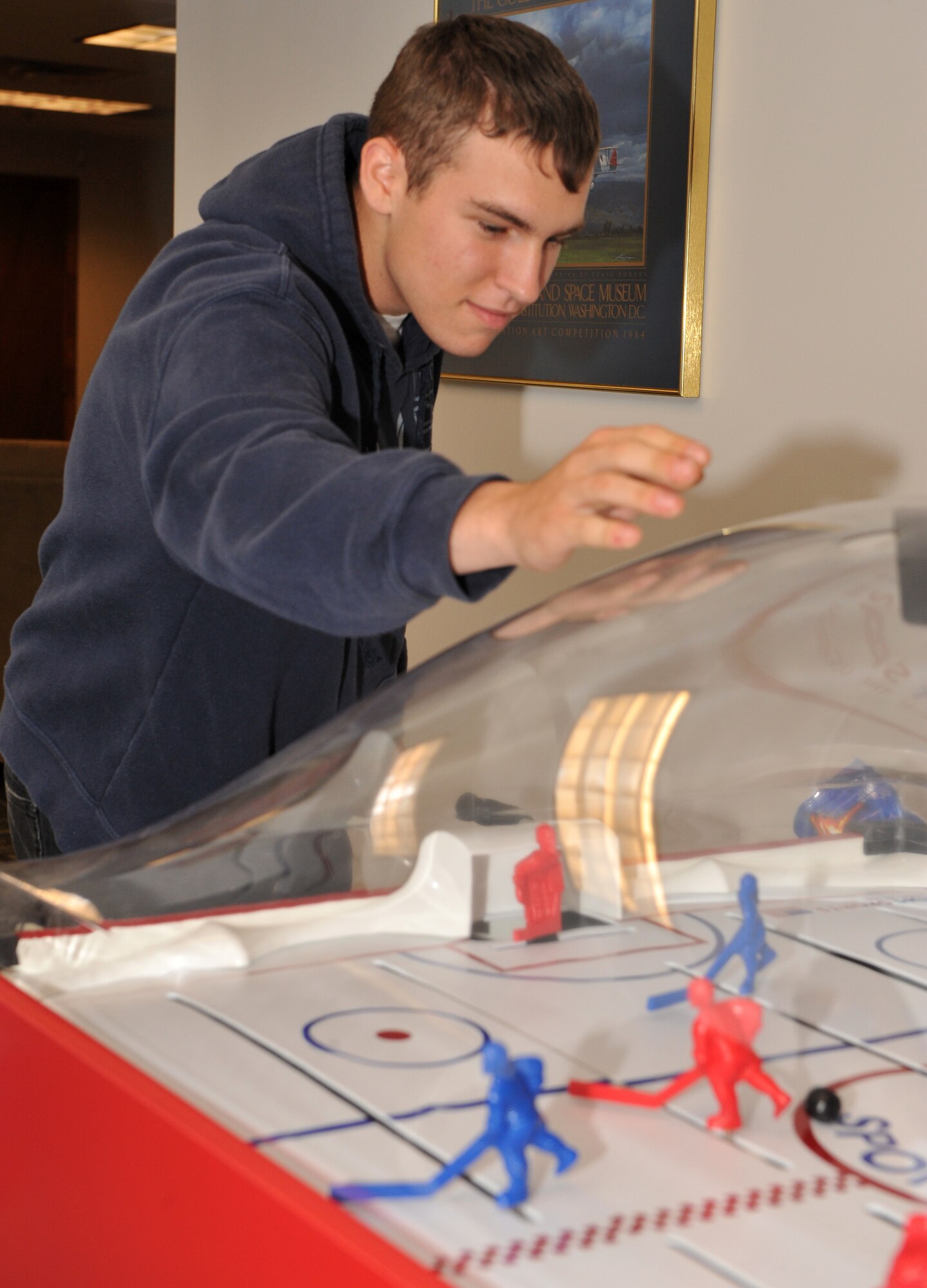 Airman 1st Class Brett Tyerya, a 19th Maintenance Operations Squadron maintenance analysis, plays table hockey at the Crossroads Café Oct. 20. The café provides a variety activities free of charge and is a place for Airmen to spend time with friends during their down time. (U.S. Air Force photo by Senior Airman Gul Crockett)
