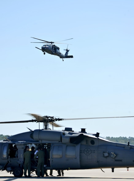 MOODY AIR FORCE BASE, Ga. -- An HH-60G Pave Hawk flies over another helicopter during the 23rd Maintenance Group’s Spouse Orientation Day here Oct. 22. The spouses were given the opportunity to fly on an HH-60 and a HC-130P Combat King during the day’s events. (U.S. Air Force photo/Airman 1st Class Joshua Green)
