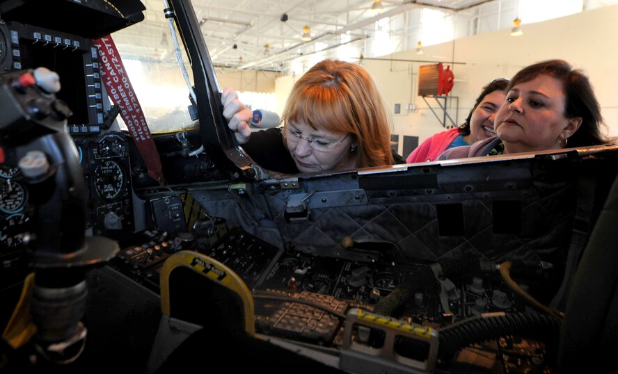 MOODY AIR FORCE BASE, Ga. -- Riney Lyons and Anna Infante, military spouses, peer inside the cockpit of an A-10C Thunderbolt II aircraft during the 23rd Maintenance Group Spouse’s Orientation Day here Oct. 22. During the event, there was a weapons load demonstration, bomb build demonstration, and an A-10 and HC-130P Combat King aircraft display during the Spouse’s Orientation Day. (U.S. Air Force photo/Airman 1st Class Benjamin Wiseman)