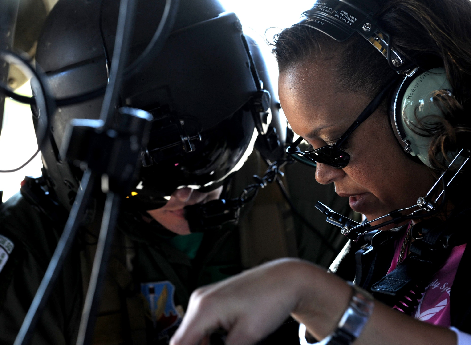 MOODY AIR FORCE BASE, Ga. -- Rhonda Robinson, military spouse, secures herself in an HH-60G Pave Hawk as it prepares to take off during the 23rd Maintenance Group Spouse’s Orientation Day here Oct. 22. Spouses flew in groups in a Pave Hawk helicopter and a HC-130P Combat King aircraft. (U.S. Air Force photo by Airman 1st Class Benjamin Wiseman)