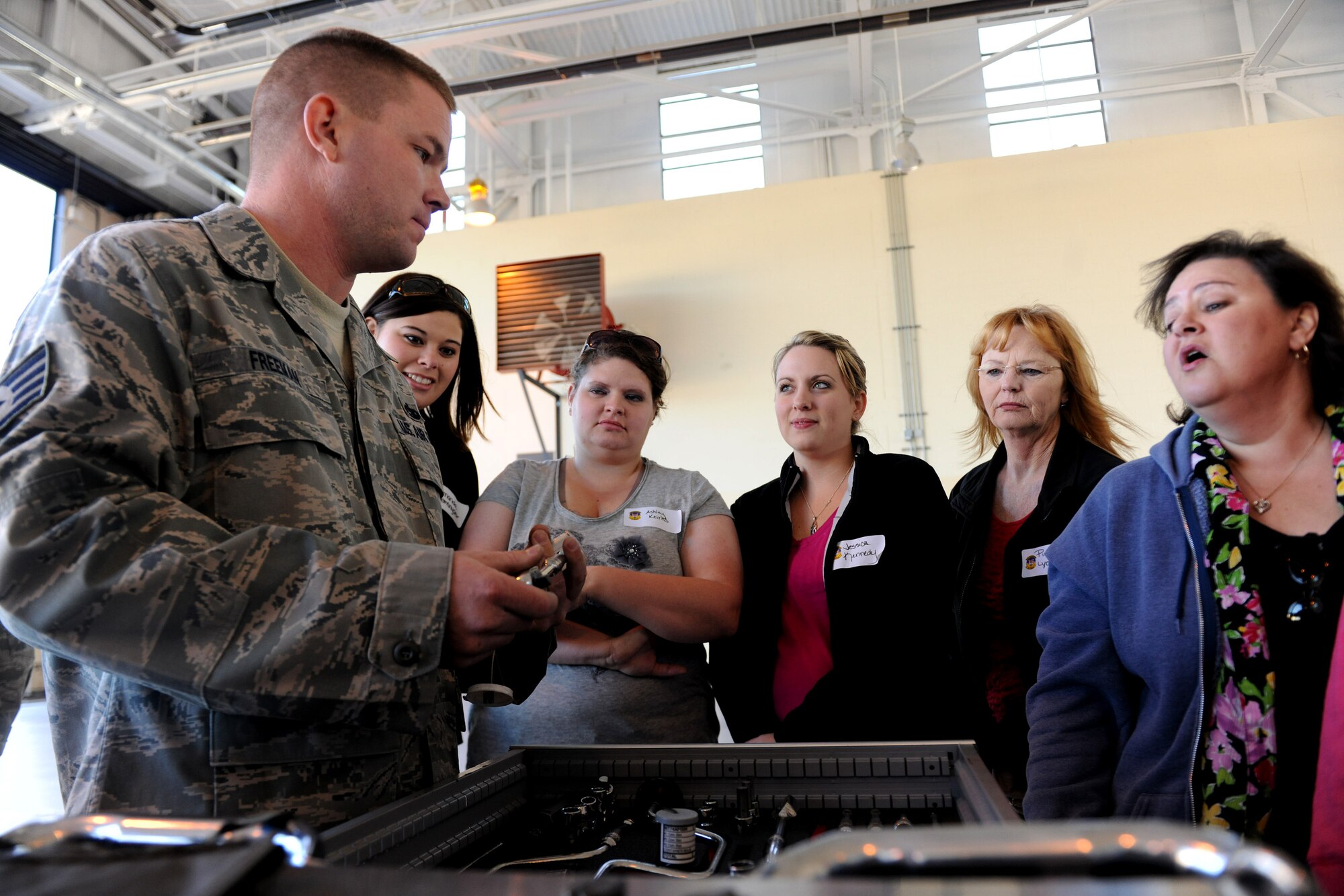 MOODY AIR FORCE BASE, Ga. -- Staff Sgt. Andrew Freeman, 23rd Aircraft Maintenance Squadron crew chief, shows a wide variety of tools used during aircraft maintenance to spouses attending the 23rd Maintenance Group Spouse’s Orientation Day here Oct. 22. The all day event gave spouses the opportunity to visit squadrons within the 23rd MXG. (U.S. Air Force photo/Airman 1st Class Benjamin Wiseman)