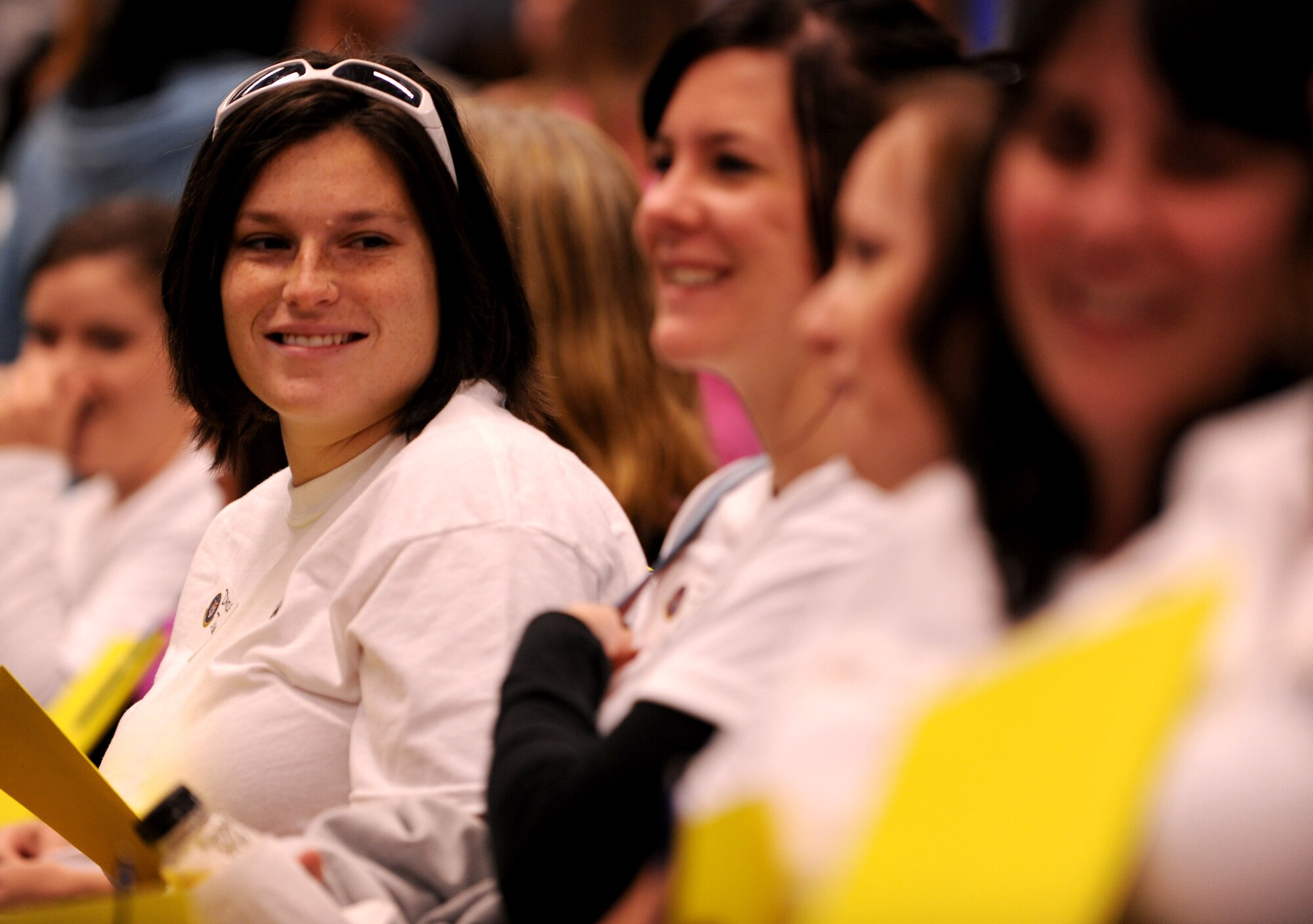 MOODY AIR FORCE BASE, Ga. -- Danielle Johnson, military spouse, sits with other spouses from the 23rd Component Maintenance Squadron before the start of the 23rd Maintenance Group Spouse’s Orientation Day here Oct. 22. The spouses were divided up by squadron for the duration of the tour and activities throughout the day. (U.S. Air Force photo/Airman 1st Class Benjamin Wiseman)