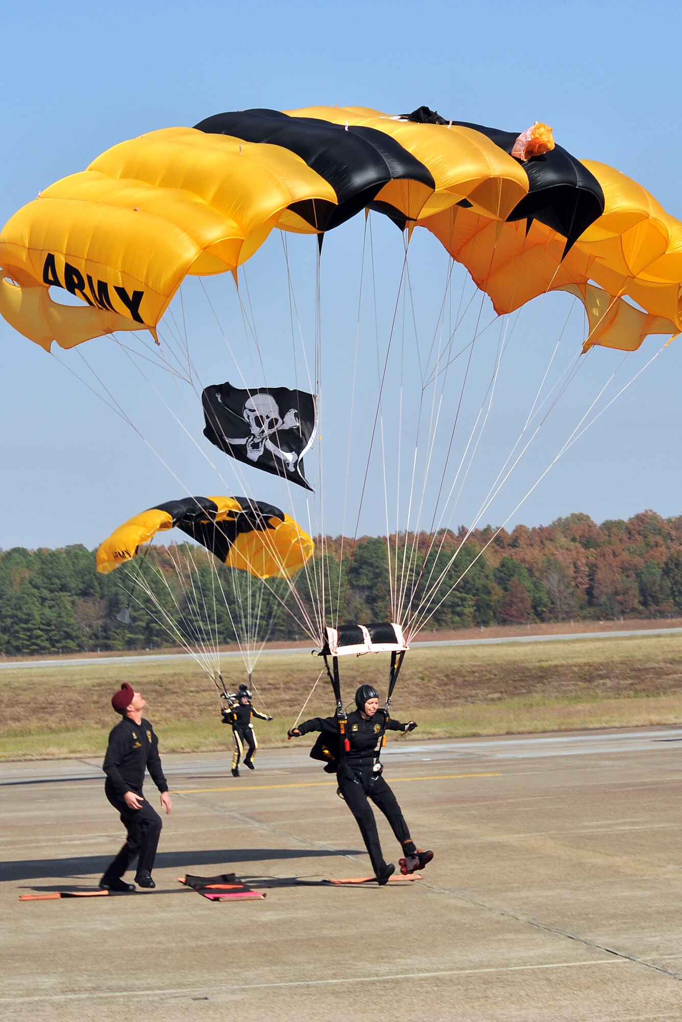 Two members of the Golden Knights Strategic Army Corps Sport Parachute Team descend to the base's flightline Oct. 9 during the Thunder Over the Rock air show and open house. For more than 44 years the Golden Knights have been entertaining audiences at air shows, in competitions and with high-profile tandems. (U.S. Air Force photo by Staff Sgt. Chris Willis)