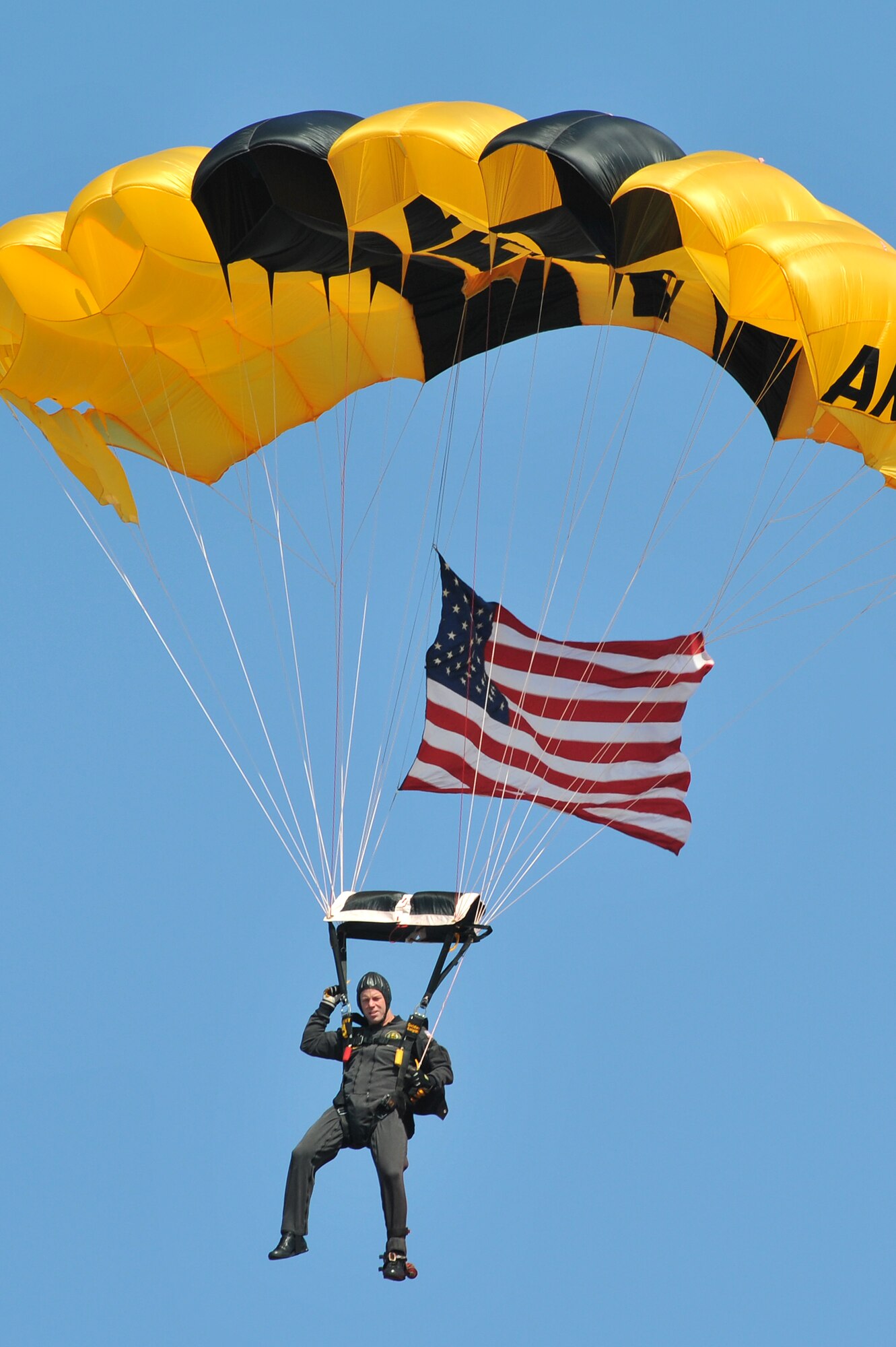 A member of the Golden Knights Strategic Army Corps Sport Parachute Team descends to the base's flightline Oct. 9 during the Thunder Over the Rock air show and open house. For more than 44 years the Golden Knights have been entertaining audiences at air shows, in competitions and with high-profile tandems. (U.S. Air Force photo by Staff Sgt. Chris Willis)