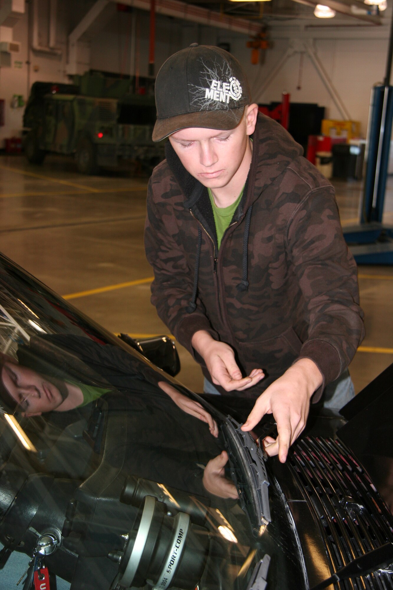 Airman 1st Class Brian Jordan, 341st Logistics Readiness Squadron vehicle maintenance apprentice, checks a windshield wiper for wear during a free personally-owned vehicle inspection Oct. 17 at building 870. (U.S. Air Force photo/Staff Sgt. Dillon White)