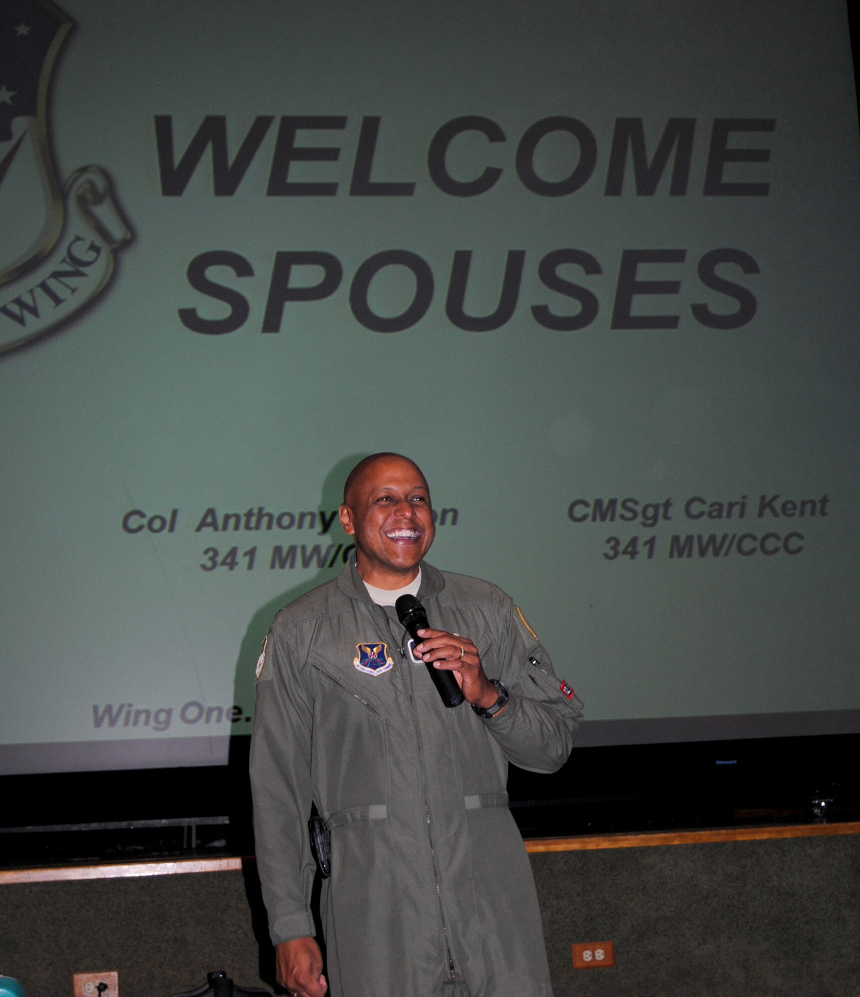 Col. Anthony Cotton, 341st Missile Wing commander, opens 2010’s 2nd Spouses' Call meeting up by greeting those in attendance and goes over the evening itinerary at the base auditorium Oct. 12. (U.S. Air Force photo/Airman 1st Class Kristina Overton)