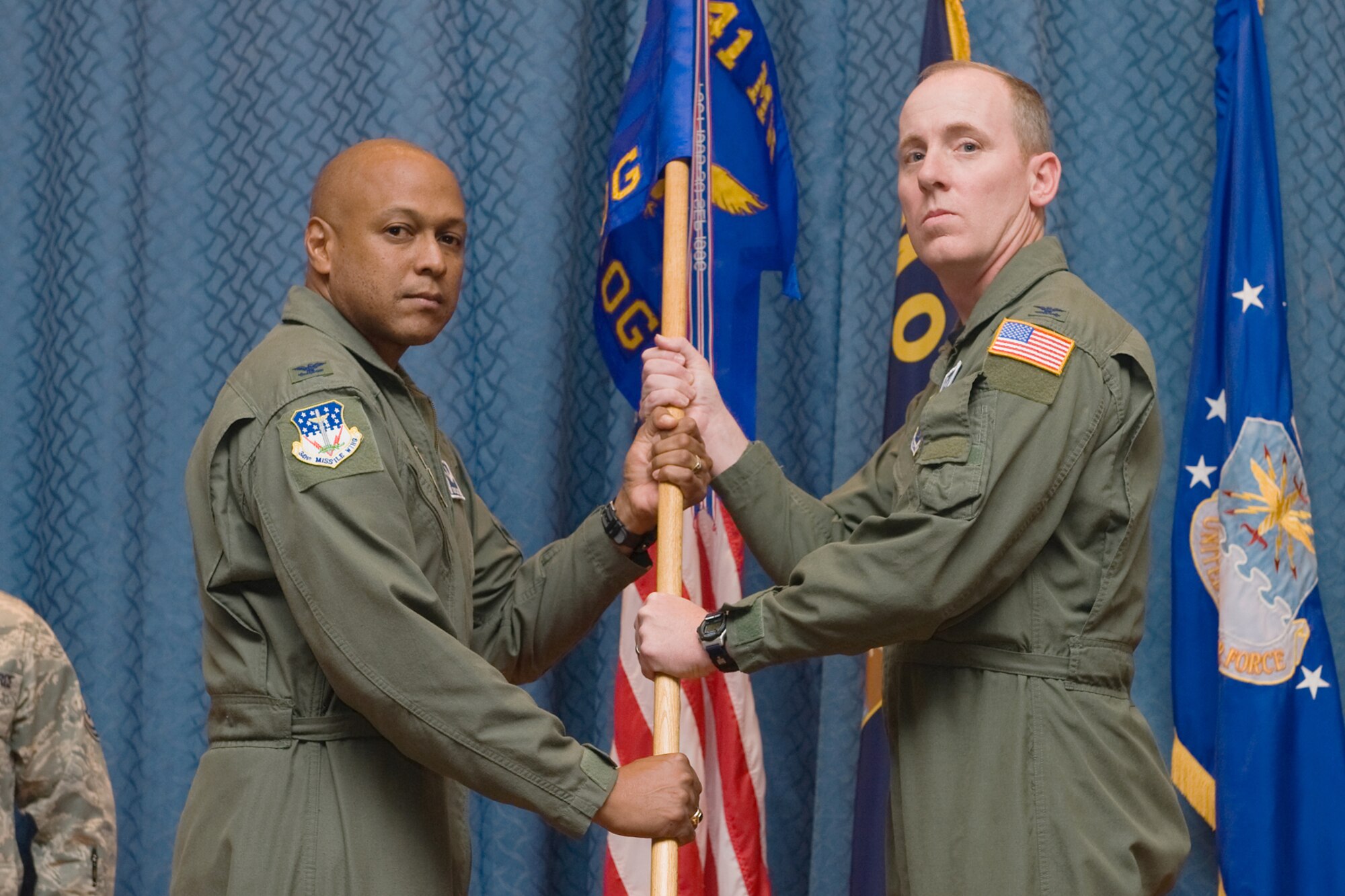 Col. Edward Rimback accepts command of the 341st Operations Group from Col. Anthony Cotton, 341st Missile Wing Commander, October 18, 2010. (U.S. Air Force Photo / Beau Wade)