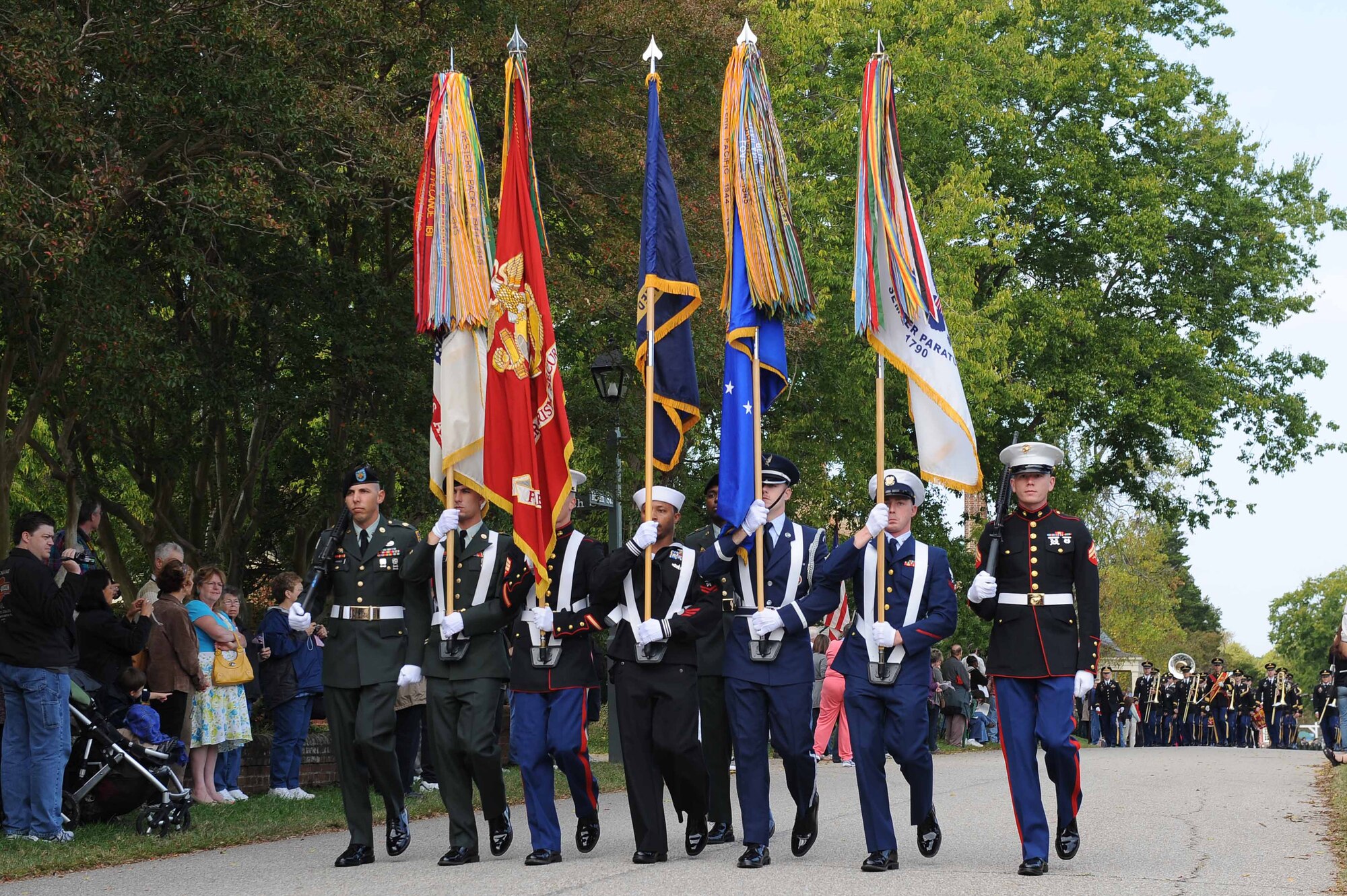 YORKTOWN, Va. -- Local military members from all branches march with their respective service branch flags during the 2010 Yorktown Day parade in Yorktown Oct. 19. Military members represented their branch while commemorating the Battle of Yorktown, which brought an end to the American Revolutionary War.(U.S. Air Force photo/Master Sgt. Anna Hayman)