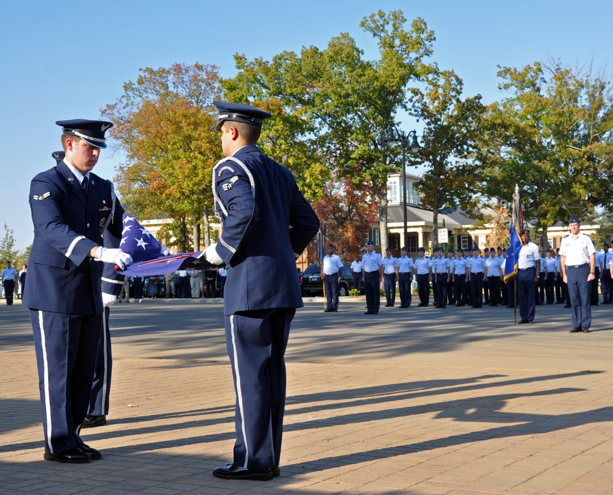 Base Honor Guard members Airman 1st Class Shayne Allen, 14th Medical Operations Squadron, and Senior Airman Gregory Ramirez, 14th Civil Engineer Squadron, fold the U.S. flag during the wing retreat ceremony held Oct. 18 at Smith Plaza. (U.S. Air Force photo/Airman 1st Class Chase Hedrick).