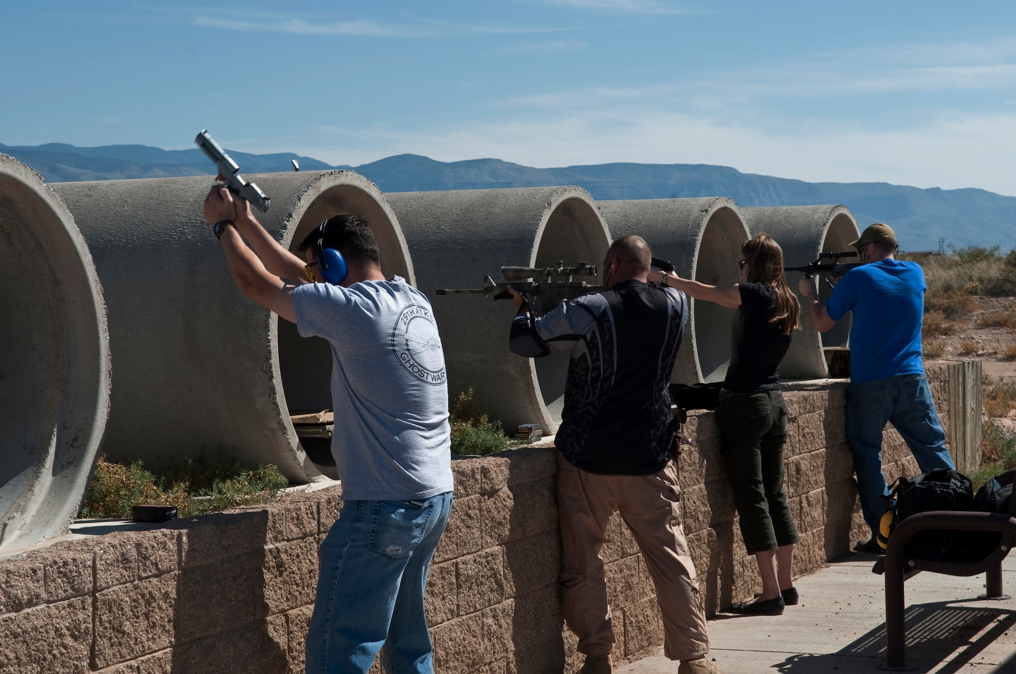 HOLLOMAN AIR FORCE BASE, N.M. -- Members of the 6th Reconnaissance Squadron and the 29th Attack Squadron fire their weapons during a shooting competition at the Apache Sports Range Oct. 19, 2010. The competition was hosted by the 6th RS and the 29th ATKS, and they were joined by members of associate units to compete for the title of pistol champion, rifle champion, shotgun champion and three-gun champion -- a combination of pistol, rifle and shotgun. The primary goal of the competitions was to build unit morale and to educate people on firearm safety. (U.S. Air Force photo by Airman 1st Class Joshua Turner/Released)