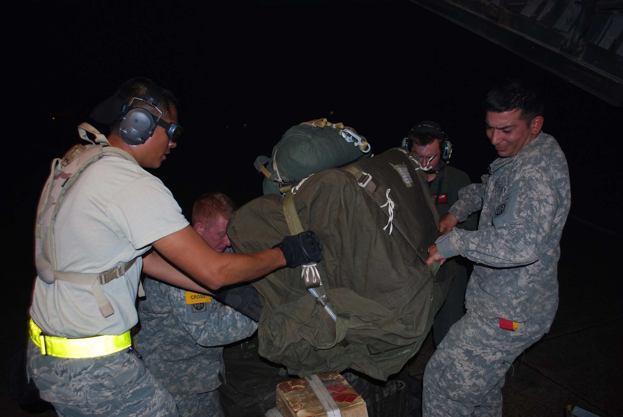 Senior Airman Julio Laureano, 570th Global Mobility Squadron assists Soldiers from the 82nd Airborne Division with loading supplies. (U.S. Air Force Photo/Capt Paradon Silpasornprasit)

