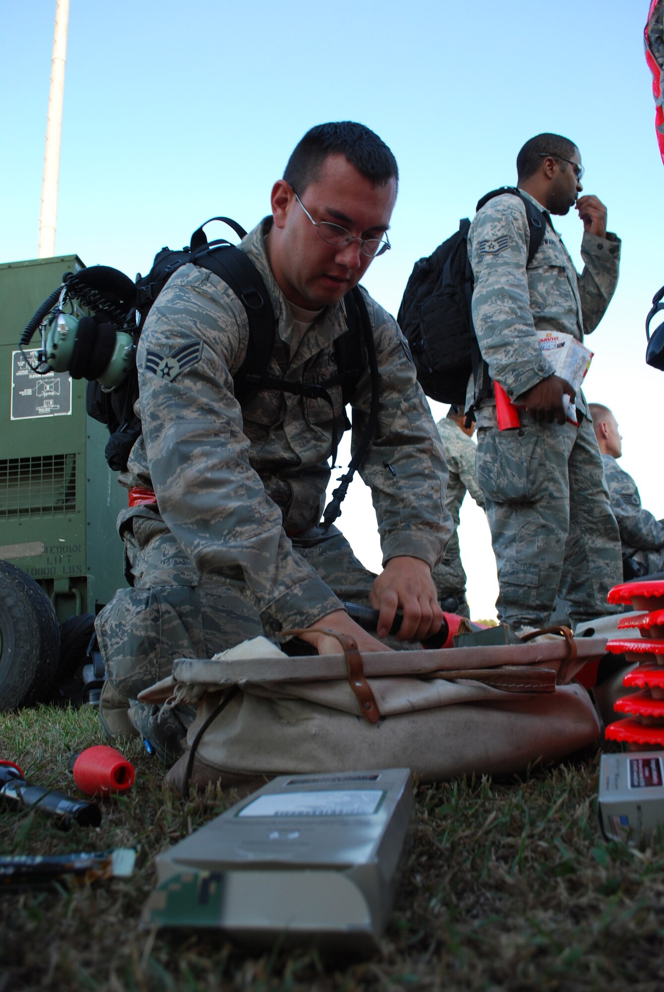 Senior Airman Jordan Slaughter, 570th Global Mobility Squadron aerial porter, prepares equipment prior to aircraft arrival. 