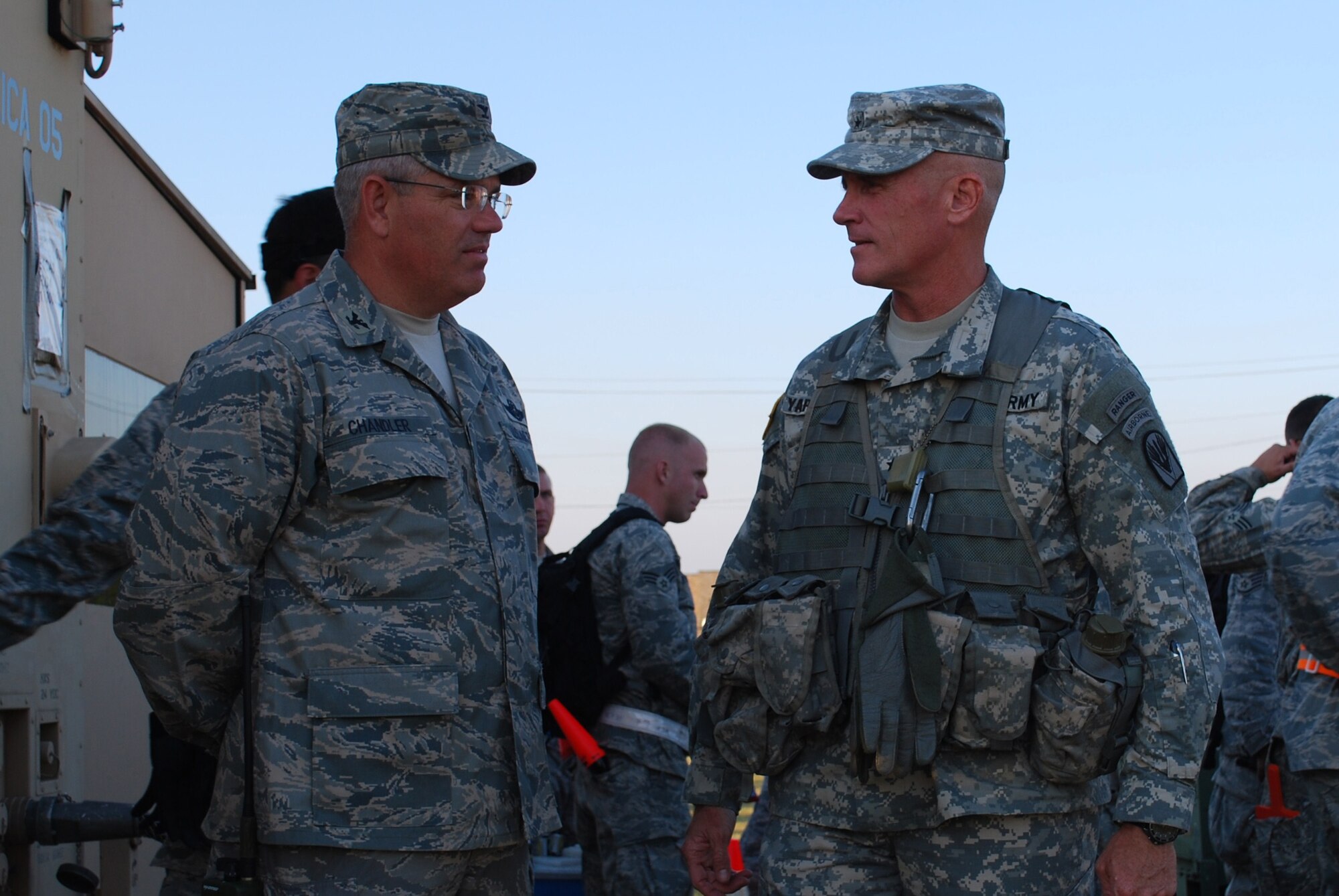 Colonel David Chandler, 570th Contingency Response Group commander, discusses operations with Brig. Gen. James Yarbrough, Joint Readiness Training Center commander. 