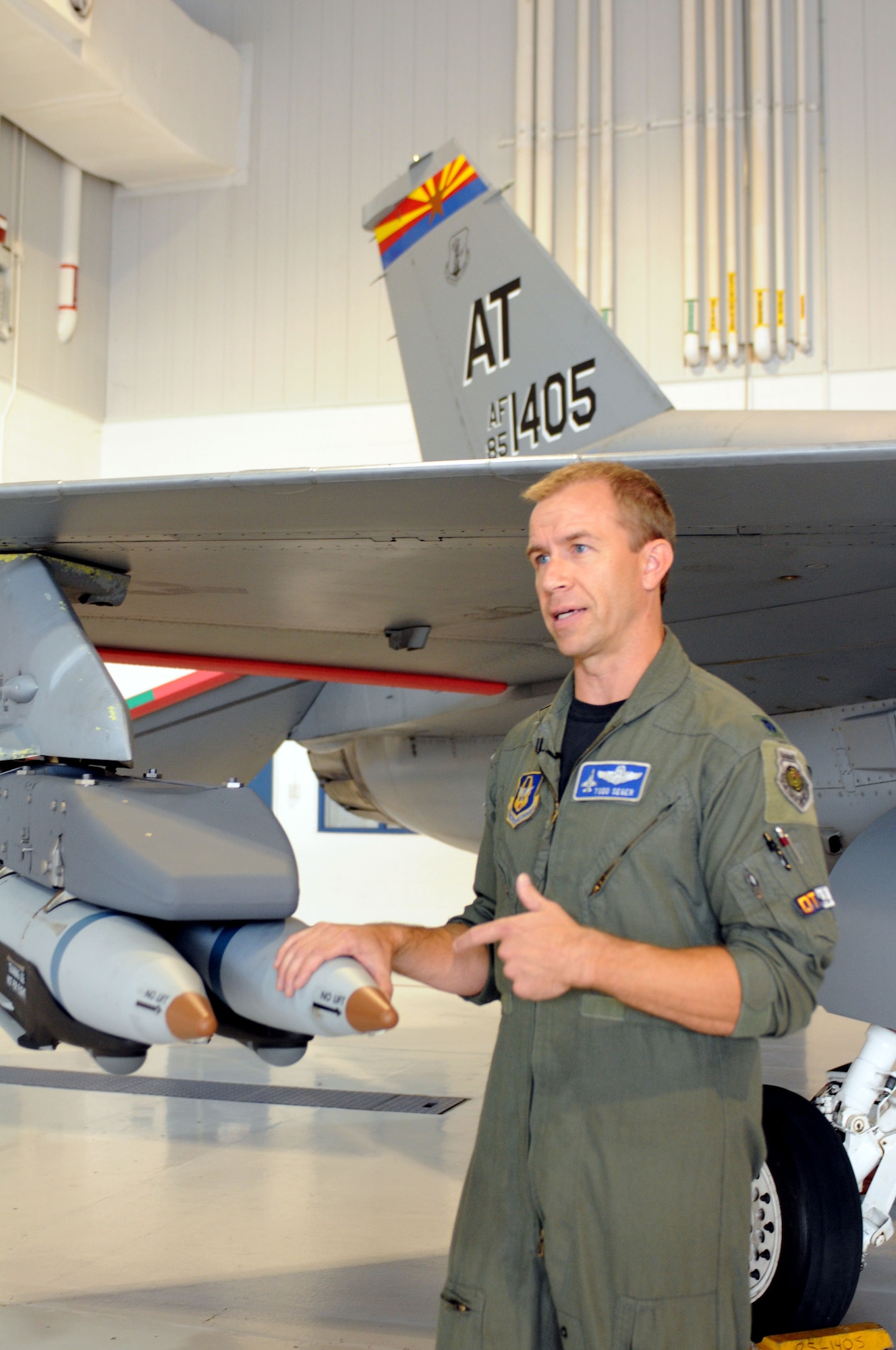 Lt. Col. Todd Seger, test pilot and combined test force director for the Air National Guard, Air Force Reserve Command Test Center, talks about new small diameter, laser guided bombs added to an early model Block 30 F-16 Fighting Falcon at the Weapons and Tactics Conference in Tucson, Ariz., Oct. 20. The test center hosted scores of Guard and Reserve warfighters during the conference to gather input for improving the capability of legacy aircraft. (US Air Force photo/Maj. Gabe Johnson) 