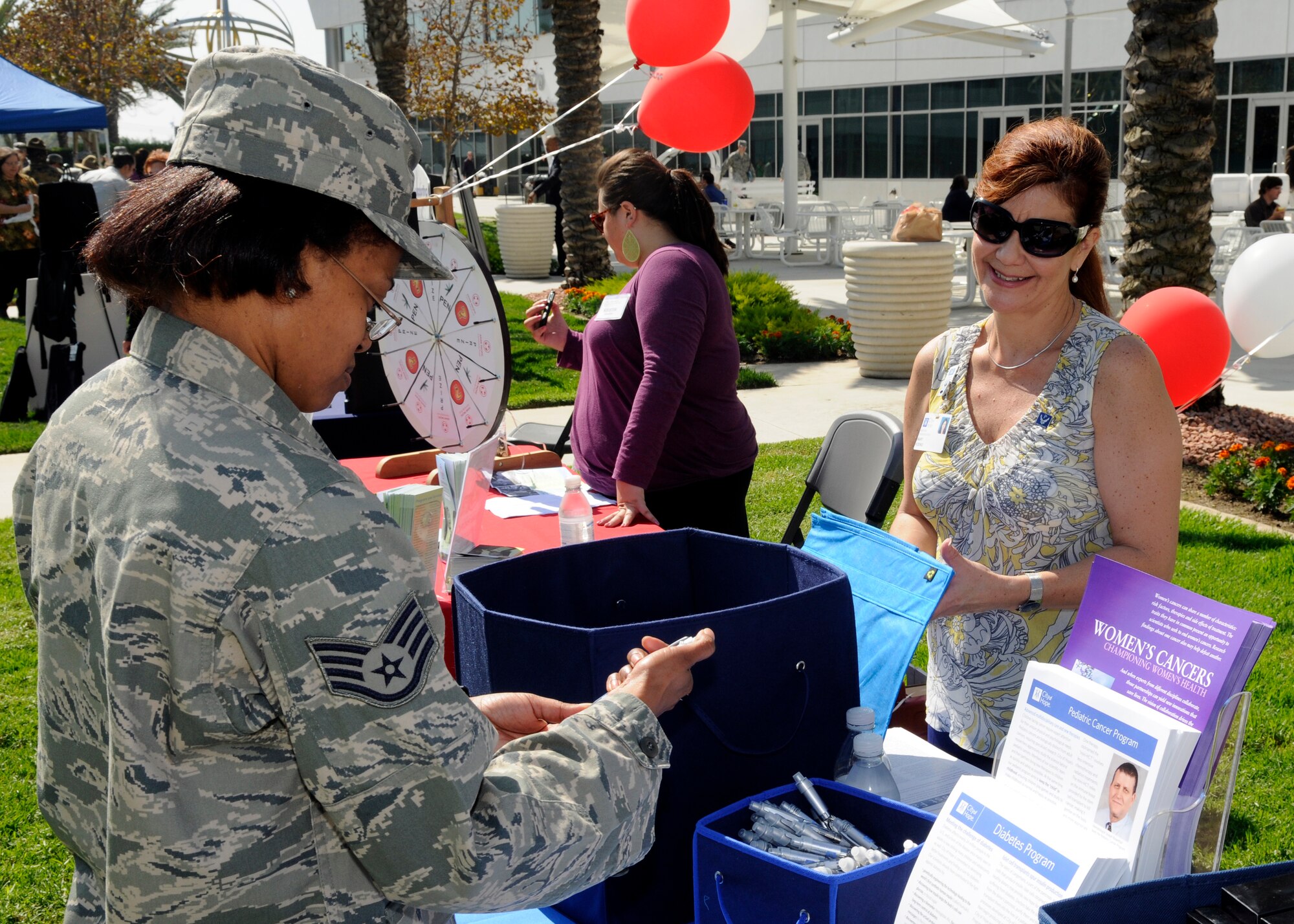 Base personnel speak with representatives from various charities at the CFC kickoff, Oct.12.  The event featured information booths, speakers, food and prizes. This year’s campaign runs through Oct. 29. (Photo by Jim Gordon)