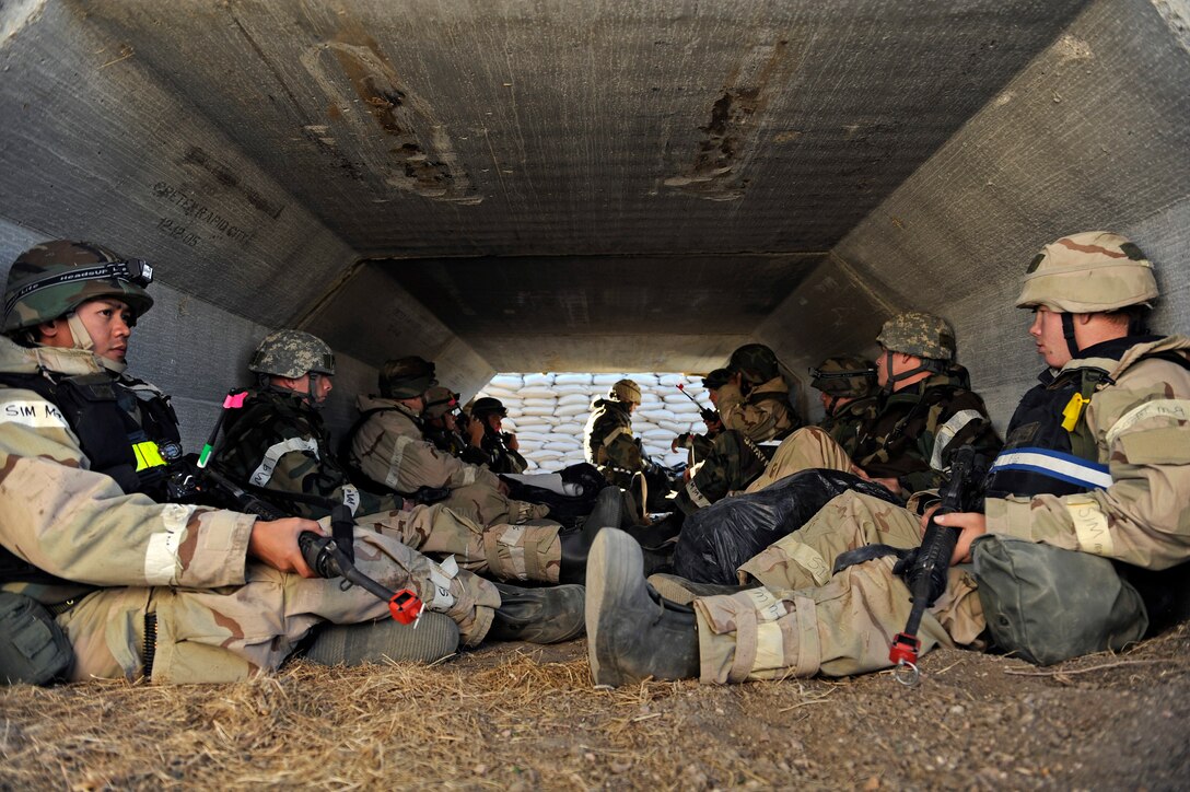 ELLSWORTH AIR FORCE BASE, S.D. - Airmen from the 28th Civil Engineer Squadron take cover inside a bunker during a Phase II Operational Readiness Inspection, Oct. 15.  The Airmen were in the bunker to protect themselves from simulated gun fire during an attack by oppositional forces.  The ORI was designed to test the overall effectiveness of the 28th Bomb Wing in a deployed environment.  (U.S. Air Force photo/Staff Sgt. Marc I. Lane)