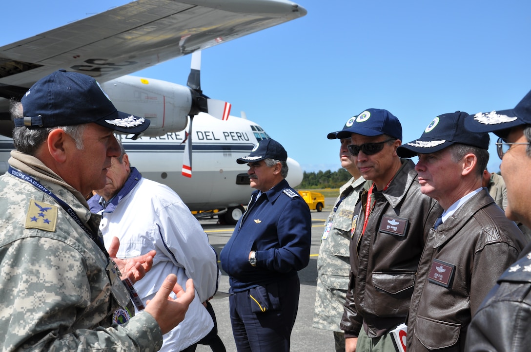 The Cooperacion 1 exercise director, Aviation General (two-star general) Luis Ili Delgado gives Lt. Gen. Glenn F. Spears, commander of 12th Air Force (Air Forces Southern) and Lt. Col. Kris Skinner, secretary general of SICOFAA and other air force leadership of the Americas a tour of the exercise headquarters.  The VIP event was part of a SICOFAA exercise, (Sistema de cooperacion de las Fuerzas Aerias de las Americas) Cooperation 1 headquartered in Puerto Montt, Chile, Oct. 4 to 14. The exercise scenario involved using the air forces of SICOFAA member nations for humanitarian assistance after a natural disaster (U.S. Air Force photo/Capt. Rebecca A. Garcia).