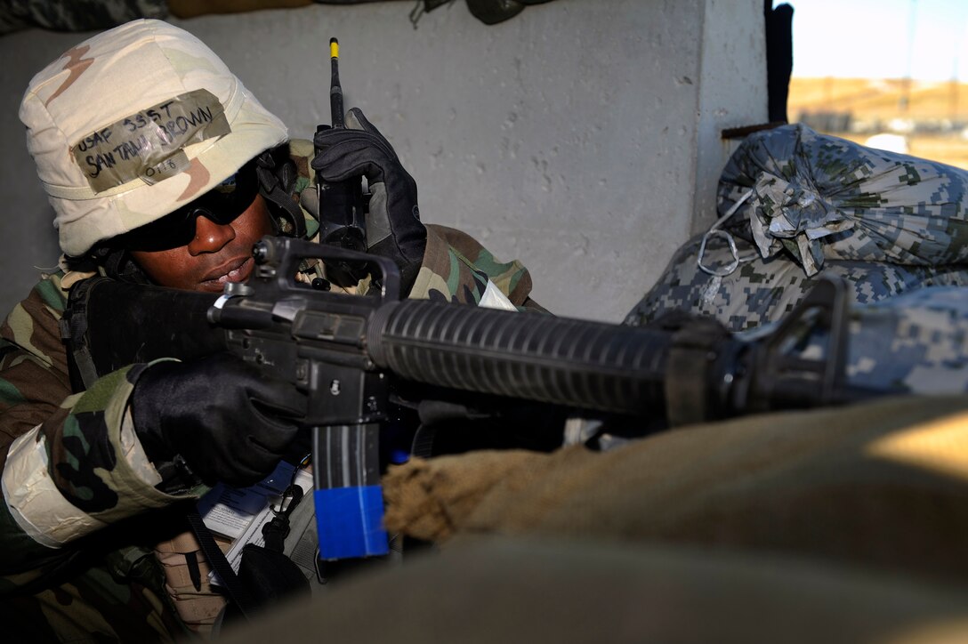 ELLSWORTH AIR FORCE BASE, S.D. – Staff Sgt Santana Brown, 28th Civil Engineer Squadron structures specialist, listens to area updates over a radio while providing security during a Phase II Operational Readiness Inspection, Oct. 15.  The 28th CES’s dual mission is to provide quality home-station engineer services for rapid, decisive, sustainable combat support, anytime-anywhere. (U.S. Air Force photo/Staff Sgt. Marc I. Lane)