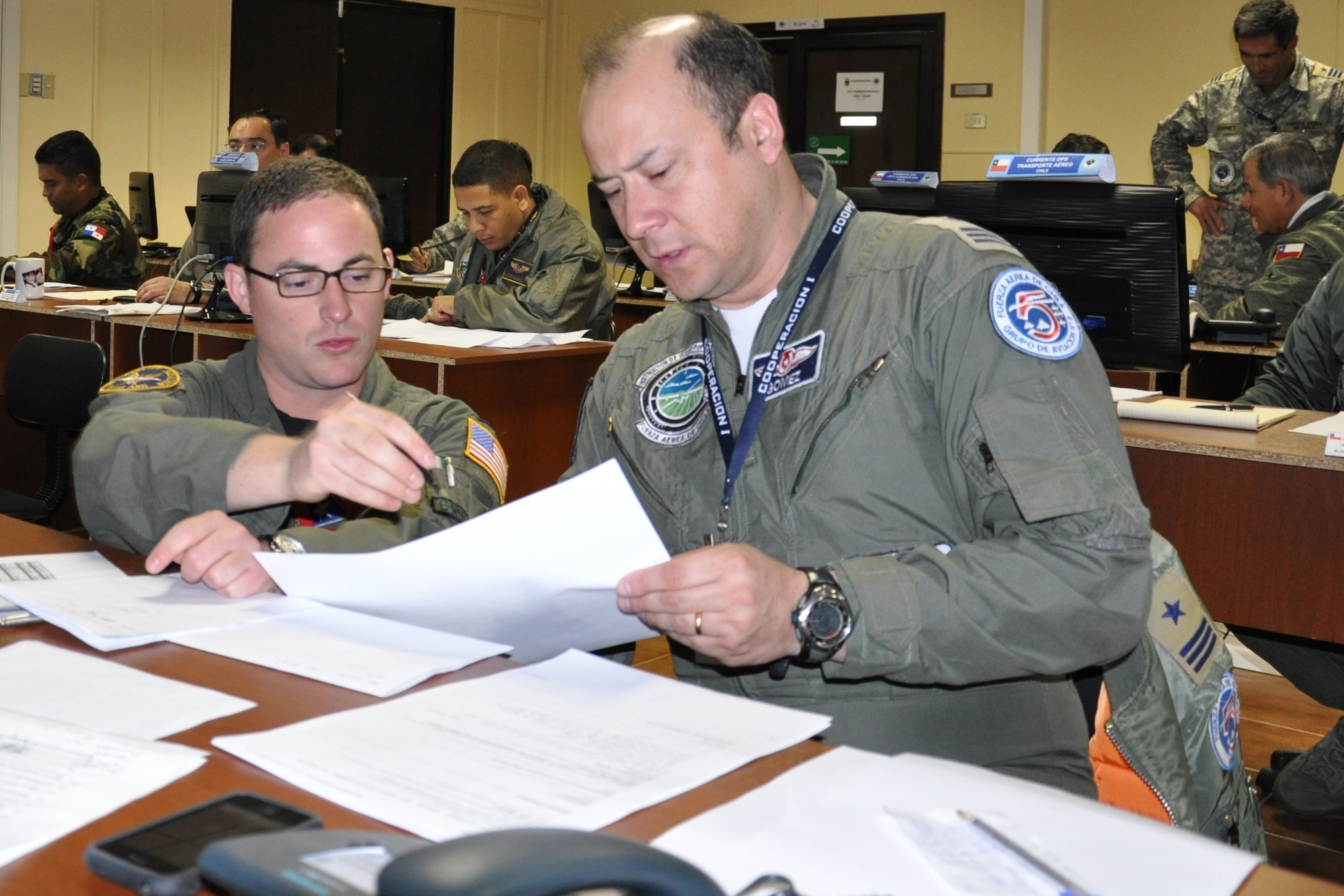 1st. Lt. William Holland, a pilot with the 136th Airlift Wing, Texas Air National Guard, coordinates U.S. air support and the movement of cargo in a Combined Air Operations Center created specifically for a SICOFAA exercise, (Sistema de cooperacion de las Fuerzas Aerias de las Americas) Cooperation 1 headquartered in Puerto Montt, Chile, Oct. 4 to 14. The exercise scenario involved using the air forces of SICOFAA member nations for humanitarian assistance after a natural disaster (U.S. Air Force photo/Capt. Rebecca A. Garcia).