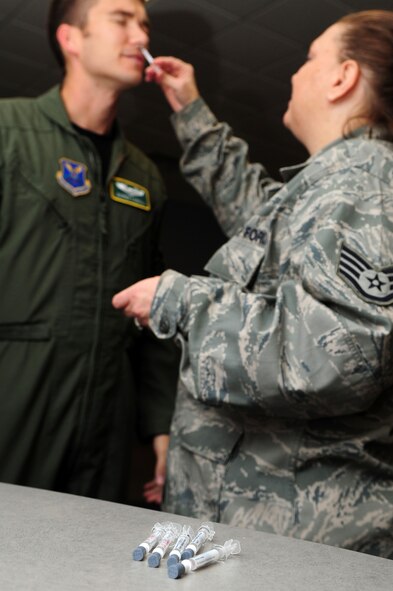 003-BARKSDALE AIR FORCE BASE, La. -- Staff Sgt. Colbie Stephenson, 2nd Medical Operations Squadron aerospace medical technician, administers the flu vaccine to Barksdale Airmen at Hoban Hall Oct. 19. The flu vaccine is mandatory for all military members and the 2010 vaccine also protects against the 2009 H1N1 Flu virus. Individuals should still prevent the spread of influenza by washing their hands frequently to reduce the spreading of germs and staying home from school or work if they contract the flu. The flu mist is the preferred delivery method by the 2nd Medical Group for military personnel; however, the flu shot is available if Airmen have allergies or other medical circumstances that prevent them from getting the mist. (U.S. Air Force photo by Senior Airman Joanna M. Kresge)
