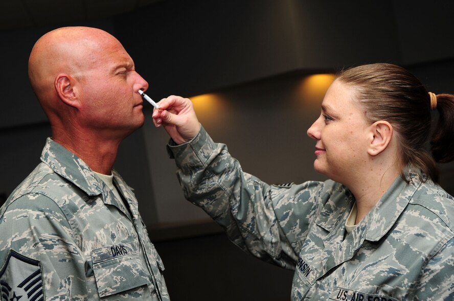 003-BARKSDALE AIR FORCE BASE, La. -- Staff Sgt. Colbie Stephenson, 2nd Medical Operations Squadron aerospace medical technician, administers the flu vaccine to Barksdale Airmen at Hoban Hall Oct. 19. The flu vaccine is mandatory for all military members and the 2010 vaccine also protects against the 2009 H1N1 Flu virus. Individuals should still prevent the spread of influenza by washing their hands frequently to reduce the spreading of germs and staying home from school or work if they contract the flu. The flu mist is the preferred delivery method by the 2nd Medical Group for military personnel; however, the flu shot is available if Airmen have allergies or other medical circumstances that prevent them from getting the mist. (U.S. Air Force photo by Senior Airman Joanna M. Kresge)