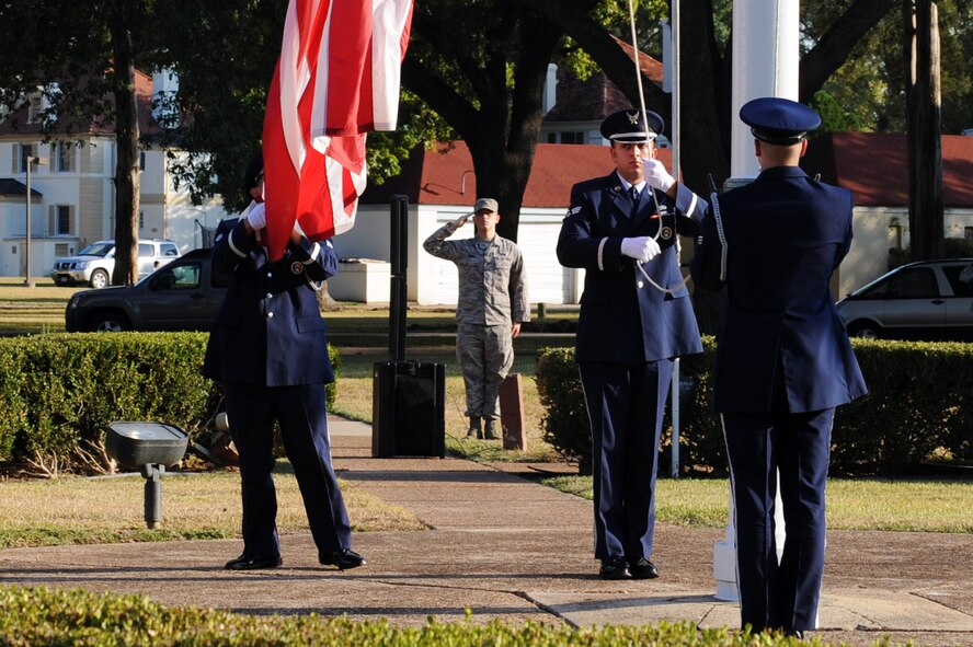BARKSDALE AIR FORCE BASE, La. -- Members of the 2nd Bomb Wing Honor Guard lower the flag during a retreat ceremony, Oct. 20. The retreat ceremony serves a two-fold purpose -- it signals the end of the official duty day and pays respect to the flag. (U.S. Air Force photo/Senior Airman Brittany Y. Bateman)(RELEASED)