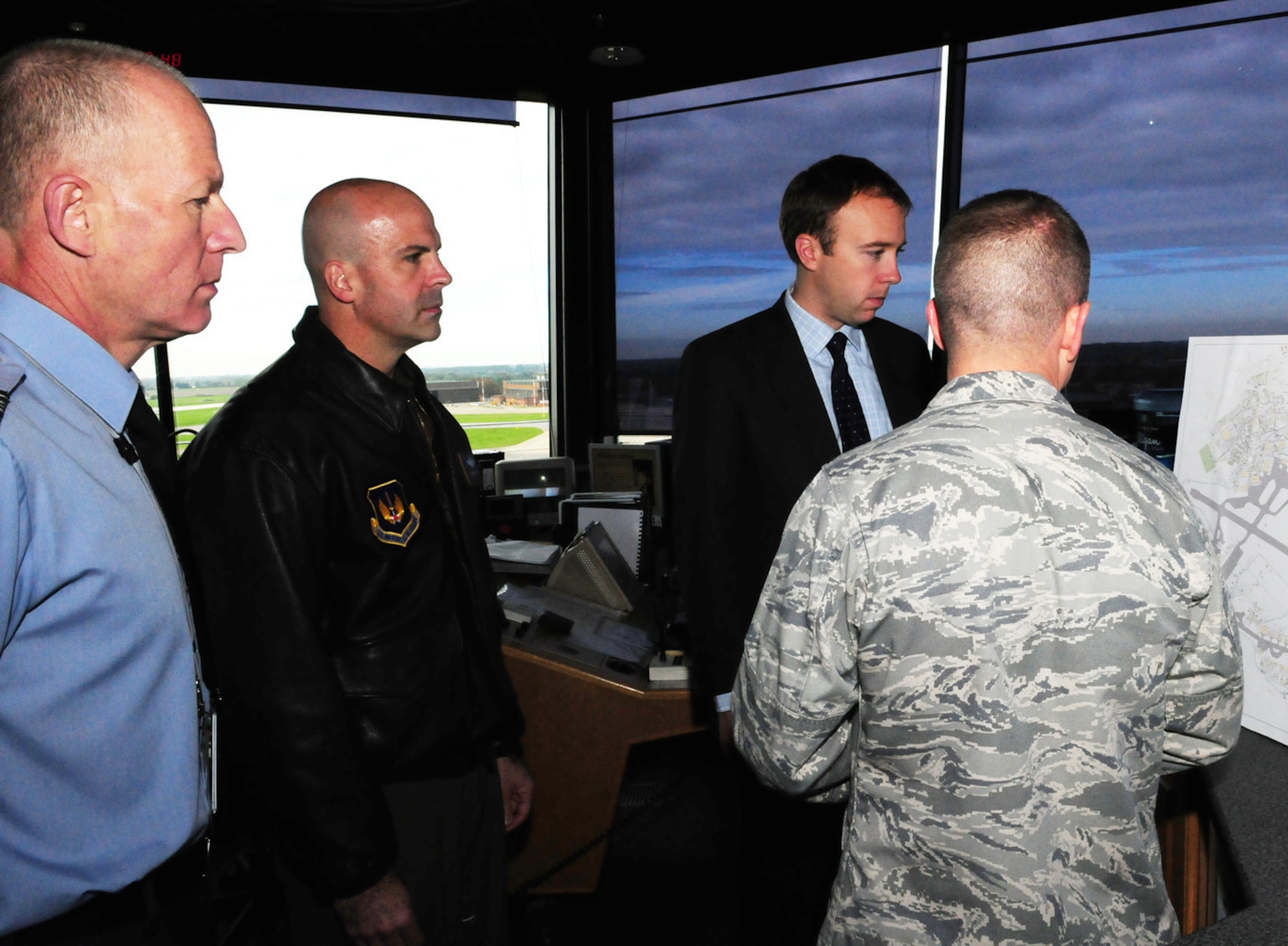 RAF MILDENHALL -- Matthew Hancock, (second right) Member of Parliament for West Suffolk, gets a quick run-down of the base from Lt. Col. Matt Greene, (right), 100th Civil Engineer Squadron commander, at the air traffic control tower during his visit here Oct. 22. The local MP had an orientation visit to the base and was shown around by Col. Chad Manske, (second left) 100th Air Refueling Wing commander, and Sqdn. Ldr. Rick Fryer, (left) RAF Station Commander. He also met with other members of wing leadership, and got to try out the KC-135 flight simulator. (U.S. Air Force photo/Karen Abeyasekere)