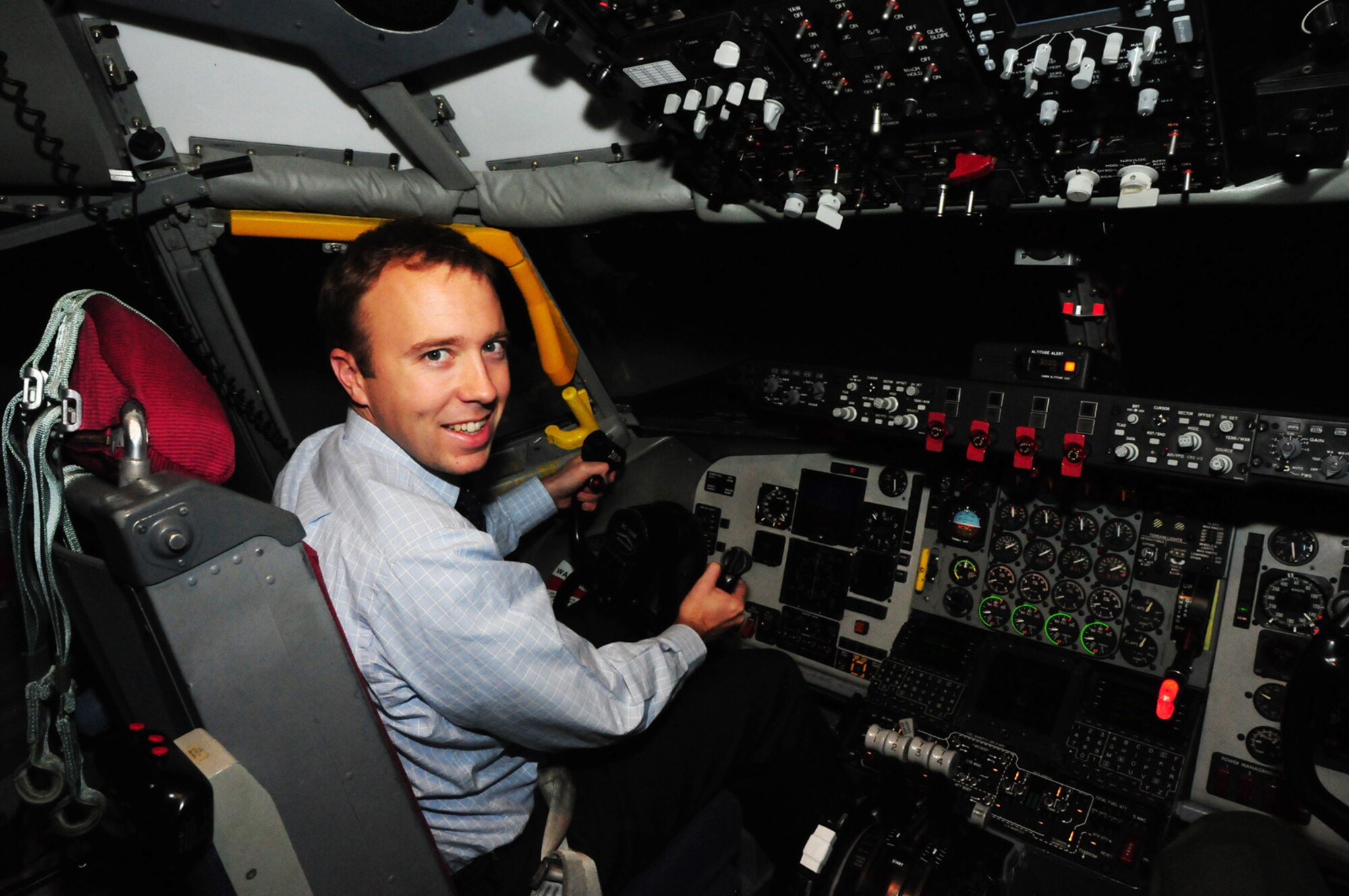 RAF MILDENHALL, England -- Matthew Hancock, Member of Parliament for West Suffolk, tries out the KC-135 flight simulator at RAF Mildenhall during a visit here Oct. 22. Mr. Hancock met with Col. Chad Manske, 100th Air Refueling Wing commander; Sqdn. Ldr. Rick Fryer, RAF Station Commander; Chief Master Sgt. Christopher Powell, 100th ARW command chief master sergeant; Sal Davidson, 100th ARW community relations advisor, and other wing leadership during his first orientation visit to RAF Mildenhall since he was elected in May. The local MP also visited the aircraft control tower during his tour here. (U.S. Air Force photo/Karen Abeyasekere)
