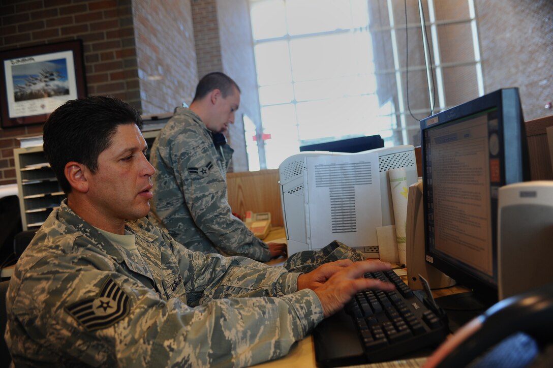 ELLSWORTH AFB, S.D. – Tech. Sgt. Michael Turgeon updates an events log, while Airman 1st Class Jared Sanchez notifies agencies across the base about an in-flight emergency, Oct. 19. Sergeant Turgeon is NCO in-charge of airfield management and Airman Sanchez is an airfield management augmentee, both assigned to the 28th Operations Support Squadron. The Airfield Management Office plays a vital role in maintaining safety on the airfield by handling the removal or dispersal of birds or wildlife, managing and inspecting the airfield. (U.S. Air Force photo/Senior Airman Kasey Close)