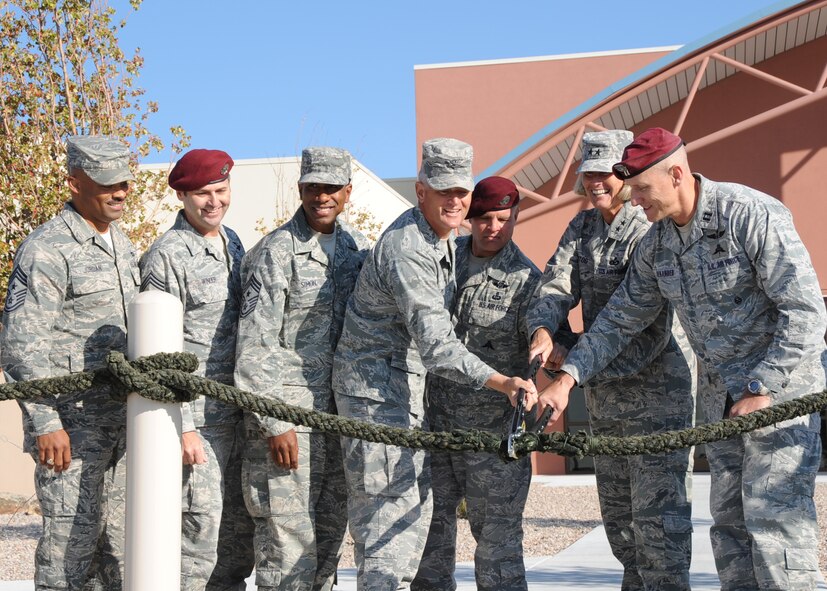 Maj. Gen. Mary Kay Hertog, 2nd Air Force commander, second from fright, presided at a ribbon-cutting ceremony Oct. 13 for the new $14.7 million Guardian Angel Rescue/Recovery Training Center at Kirtland AFB. The 32,000-square-foot building will house training operations for Combat Rescue Officers and Pararescue instructors and students at the 342nd Training Squadron, Detachment 1. A separate 25,353-square-foot logistics facility will store training gear and supplies valued at $10 million. The new facilities will enable 65 more students a year to graduate and join operational units.  U.S. Air Force photo by Dennis Carlson