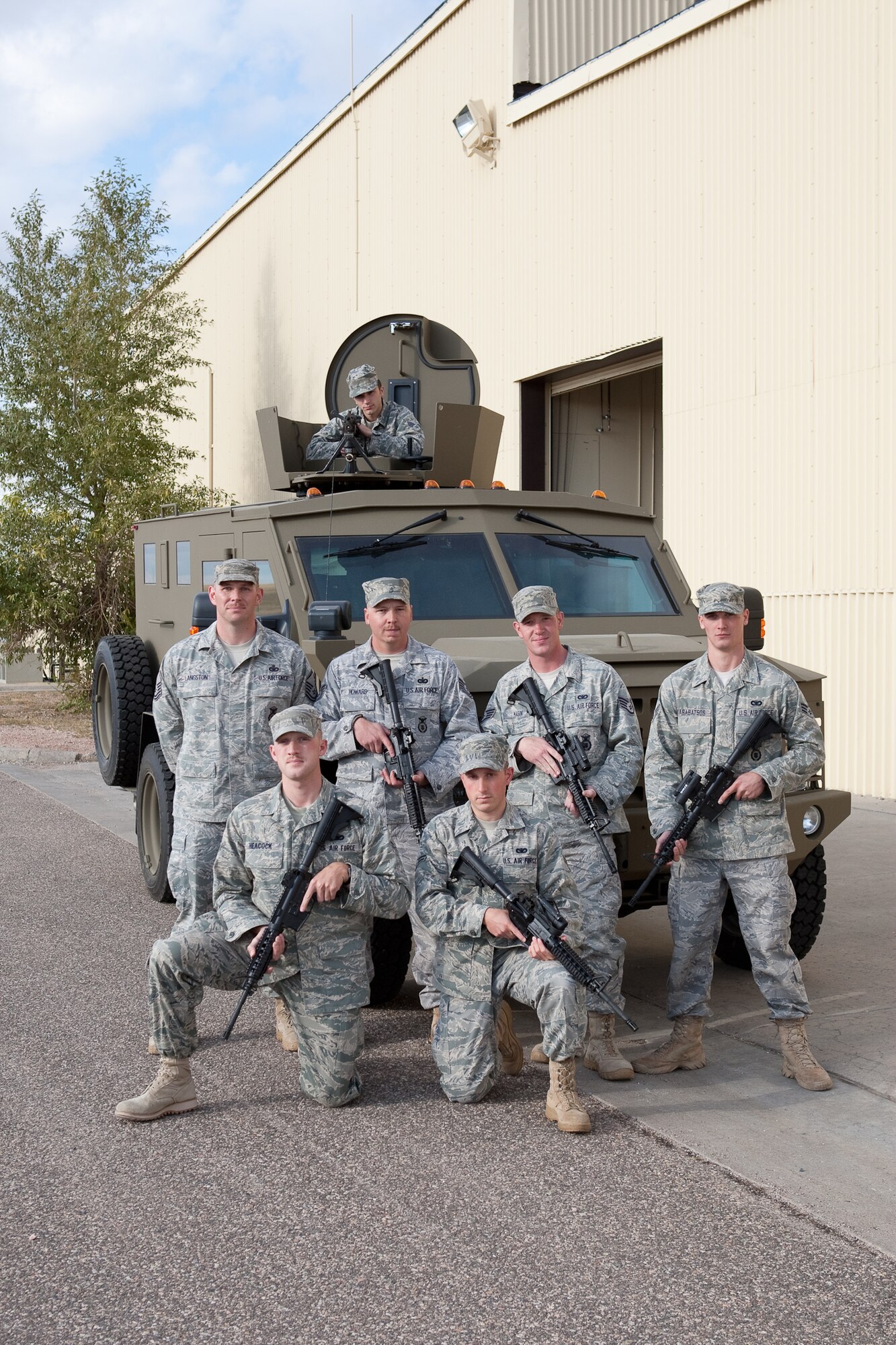 The 90th Security Forces Group Global Strike Challenge team pose for a photograph in and around a Bearcat on Oc.t 12. The team members are Tech. Sgt. Martin Howard, 90th Missile Security Forces Squadron; Staff Sgt. Cole Magin, 90th Security Forces Group  Tactical Response Force; Senior Airman Joshua Karabatsos, 90th SFG/TRF; Senior Airman Chad Henschel, 90th MSFS; Airman 1st Class Andrew Hopkins, 790th Missile Security Forces Squadron; Airman 1st Class Austin Heacock, 90th MSFS; and Airman 1st Class Michael Garrison, 90th SFG/TRF (not pictured). Master Sgt. Garrett Langston, 90th SFG/TRF, is also shown in the picture. (U.S. Air Force photo by Jeff Allred)