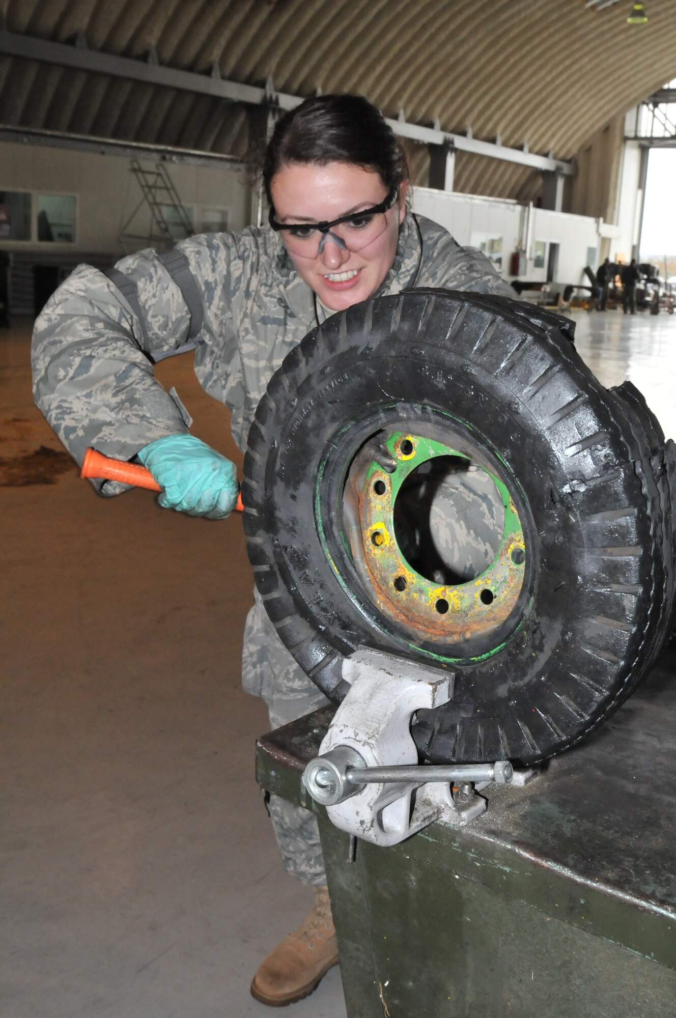 Senior Airman Shalane McLeod, 48th Maintenance Group aerospace ground equipment craftsman, removes a tire from a hydraulic cart wheel during preparations for Operation Golden Lance, Oct. 19 on Campia Turzii Air Base, Romania. Operation Golden Lance is a partnership-building exercise involving nearly 200 American Airmen. (U.S. Air Force photo/Senior Airman David Dobrydney)