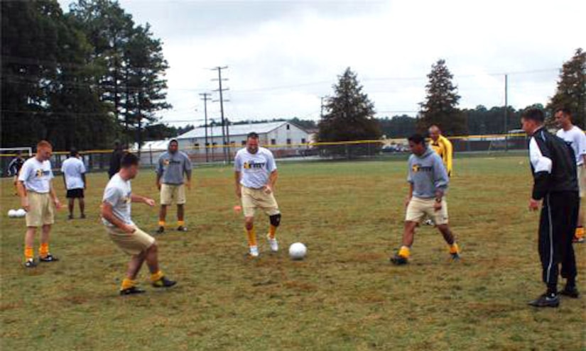 All-Army soccer team members start off practices with a warm-up keep-away drill involving two players in the middle trying to get the ball back from five surrounding players who are trying to keep it away. (Photo by Zack Shelby)
