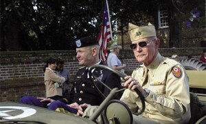 Col. Charles F. Maskell, commander, 7th Sustainment Brigade, and Yorktown Day Grand Marshall, rides along the parade route in a vintage World War II Jeep owned and driven by retired Lt. Col. Dave King.