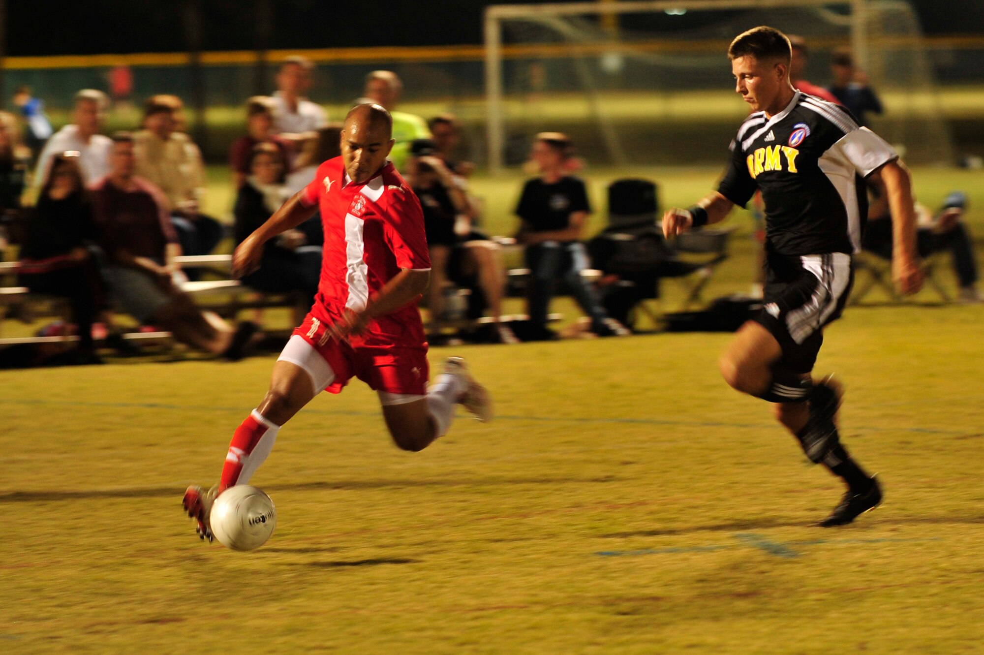 U.S. Marine Corps Sgt. Jesse Coffey, dribbles the ball down field while U.S. Army Sgt. Tyler Stratford tries to recover the ball during an Armed Forces Men's Soccer Championship Round Robin at Morgan Sports Complex, Destin, Fla., Oct. 20, 2010. The Armed Forces Championships are conducted by the Armed Forces Sports council for the purpose of promoting, understanding, goodwill, and competition among the Armed Services. Sgt. Coffey is stationed at Cherry Point, NC. Sgt. Stratford is stationed at Fort Myer, VA. (DoD Photo by Staff Sgt. Stephanie Jacobs/RELEASED)
