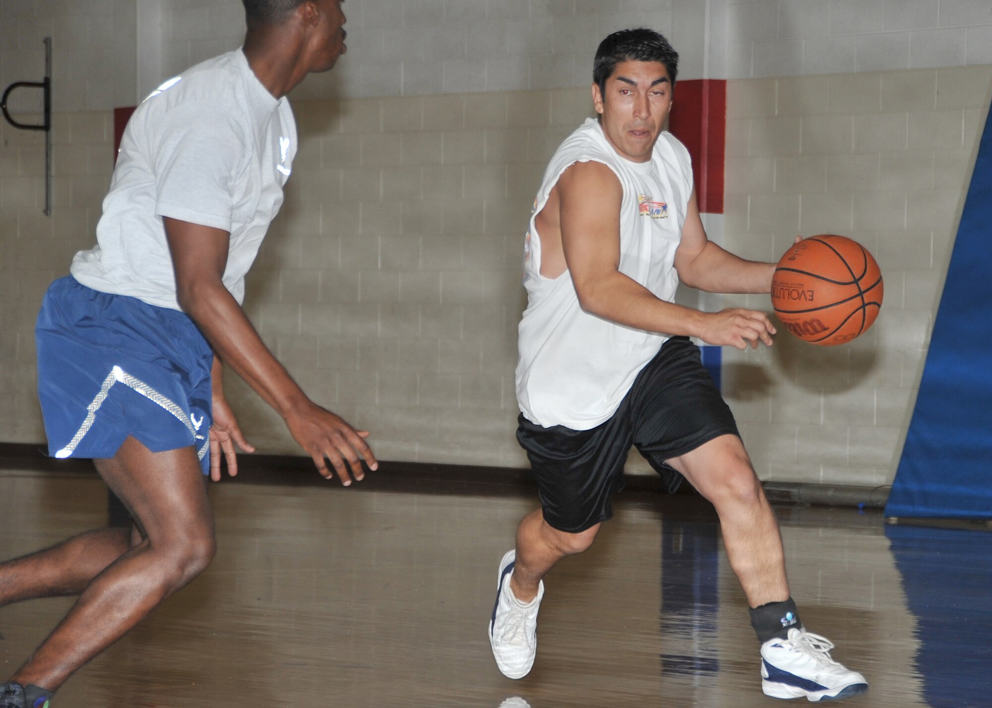 Civilian Chris Segura, 377th Civil Engineer Division moves in for a layup during a 3-on-3 basketball tournament as part of Wing Sports Day Oct. 13 at the East Fitness Center.  U.S. Air Force Photo by Todd Berenger