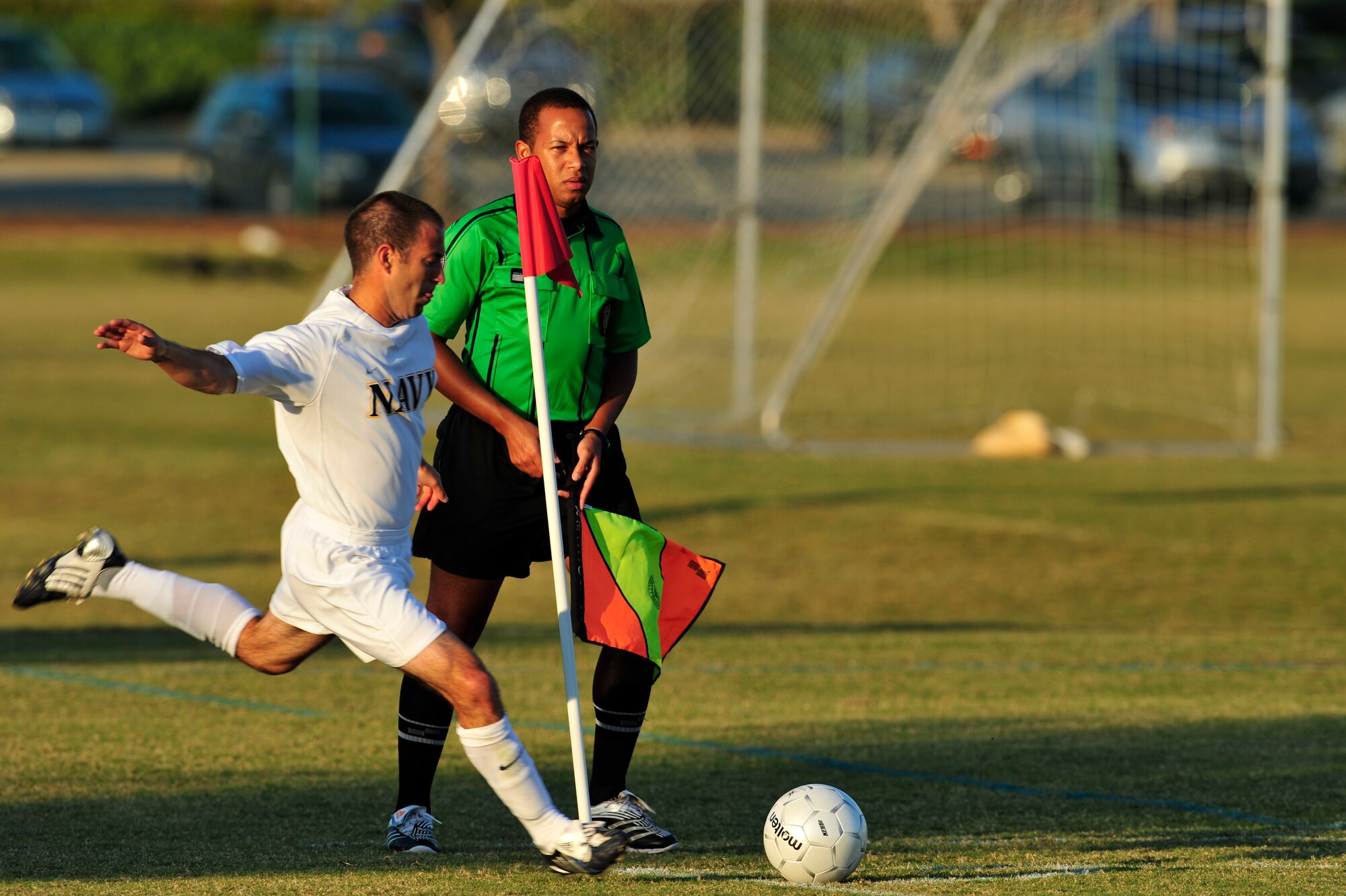 U.S. Navy Hospital Corpsman Petty Officer 1st Class Nathan Gavin, corner kicks a ball back into play while Junior Assistant Referee Stefan McHardy watches during an Armed Forces Men's Soccer Championship Round Robin match against the U.S. Air Force at Morgan Sports Complex, Destin, Fla., Oct. 20, 2010. The Armed Forces Championships are conducted by the Armed Forces Sports council for the purpose of promoting, understanding, goodwill, and competition among the Armed Services. (DoD Photo by Staff Sgt. Stephanie Jacobs/RELEASED)
