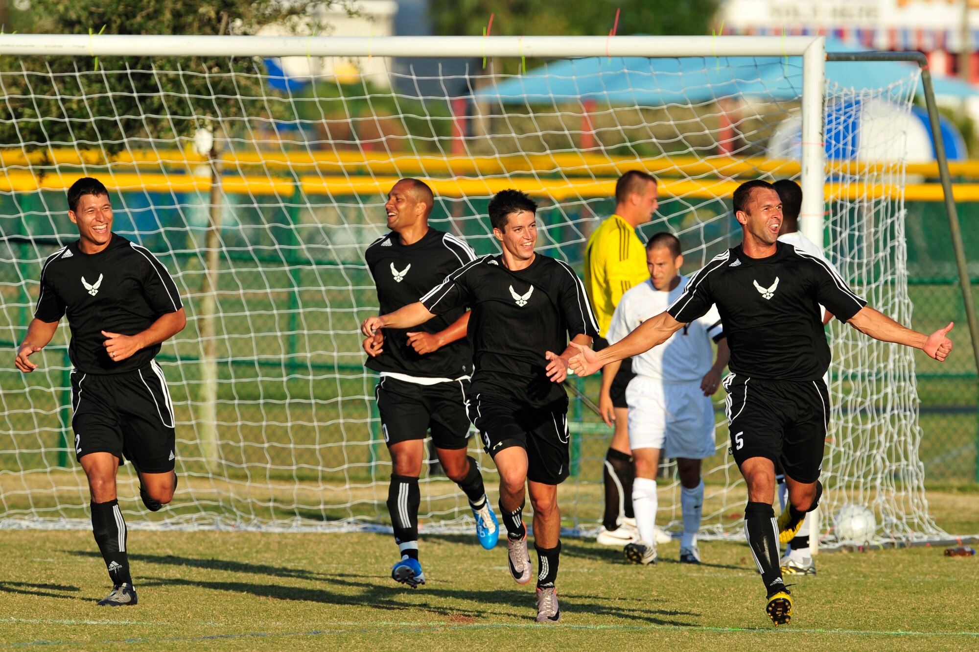 U.S. Air Force men's soccer team players rejoice after scoring a goal during an Armed Forces Men's Soccer Championship Round Robin match against the U.S. Navy at Morgan Sports Complex, Destin, Fla., Oct. 20, 2010. The Armed Forces Championships are conducted by the Armed Forces Sports council for the purpose of promoting, understanding, goodwill, and competition among the Armed Services.  (DoD Photo by Staff Sgt. Stephanie Jacobs/RELEASED)
