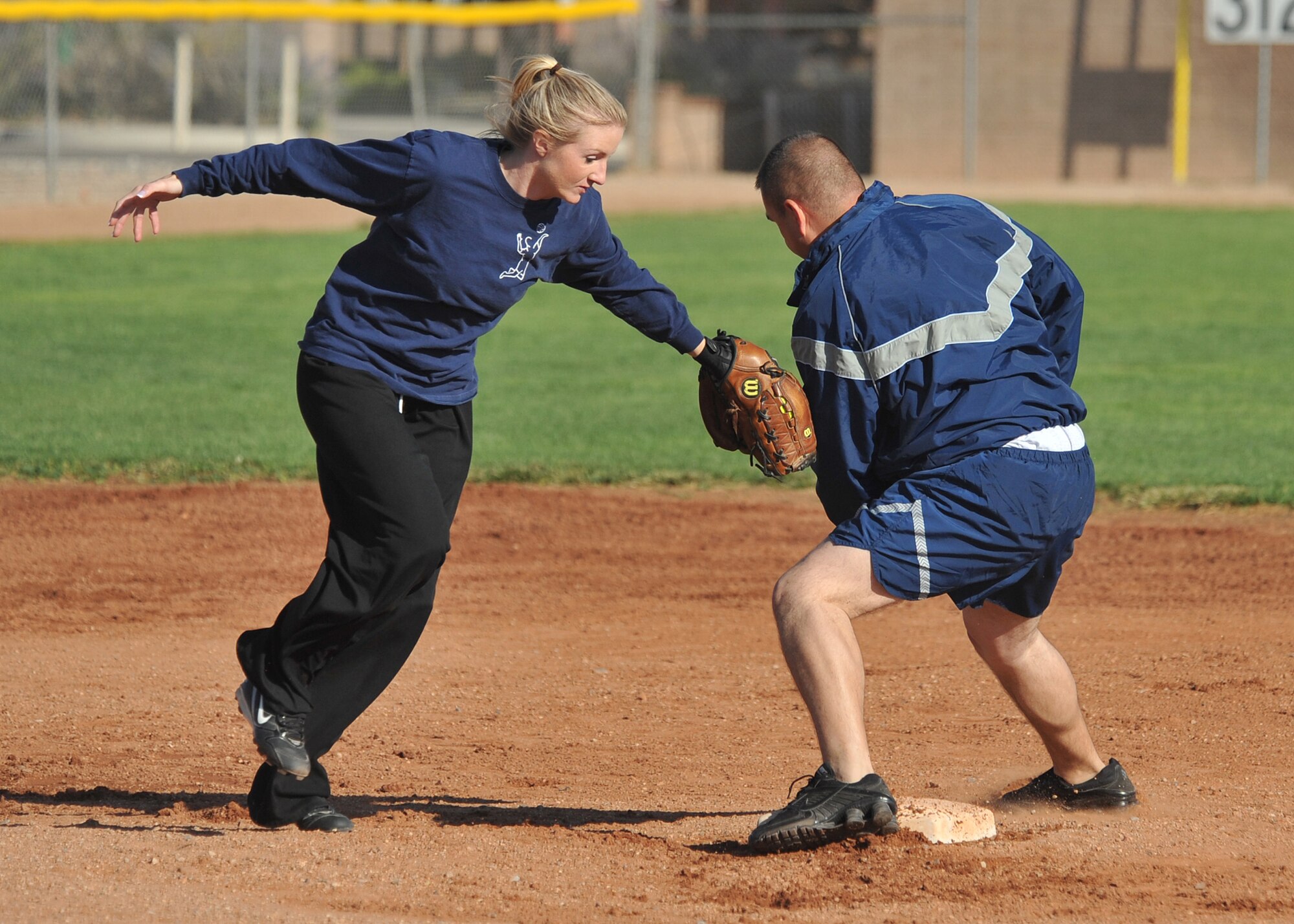 Civilian Jessica Zemer from the 498th reaches to get Master Sgt. Lawrence Prieto, 377th Logistics Readiness Squadron out at second base. U.S. Air Force Photo by Todd Berenger