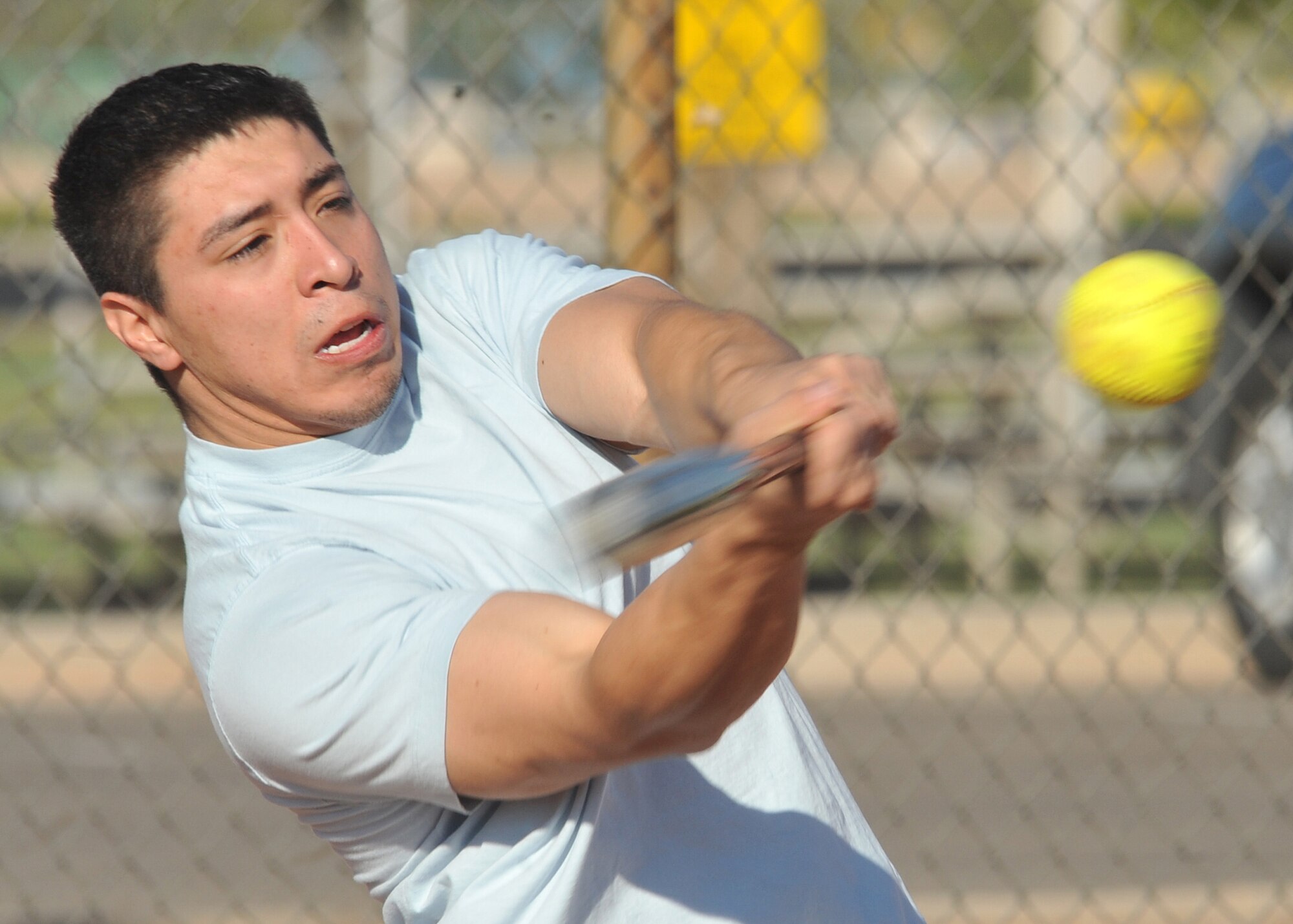 Estavan Martinez connects with the softball for a base hit during 2010 Fall Wing Sports Day. U.S. Air Force Photo by Todd Berenger