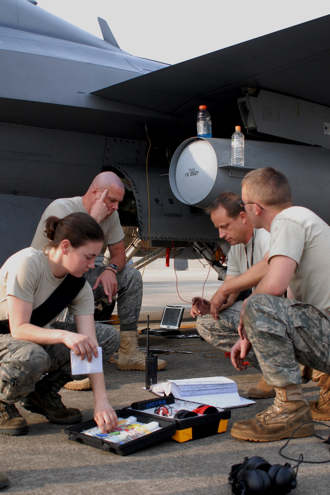 (Left to right) Senior Airman Denise Russell, 36th Aircraft Maintenance Unit, Master Sgt. Warren McCullough, 36th AMU, Maj. Daniel Mattioda, 8th Maintenance Squadron, and Senior Airman Bradley Baldus, 36th AMU, brainstorm while troubleshooting an electrical system problem in an Osan F-16 Fighting Falcon Oct. 20 during exercise Max Thunder 10-2 at Kwangju Air Base, Republic of Korea. (U.S. Air Force photo/Staff Sgt. Eric Burks)