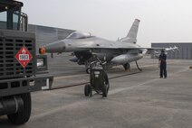 Senior Airman Jonicko Dela Cruz, 51st Aircraft Maintenance Squadron, completes paperwork while an Osan F-16 Fighting Falcon refuels Oct. 20 during exercise Max Thunder 10-2 at Kwangju Air Base, Republic of Korea. (U.S. Air Force photo/Staff Sgt. Eric Burks)