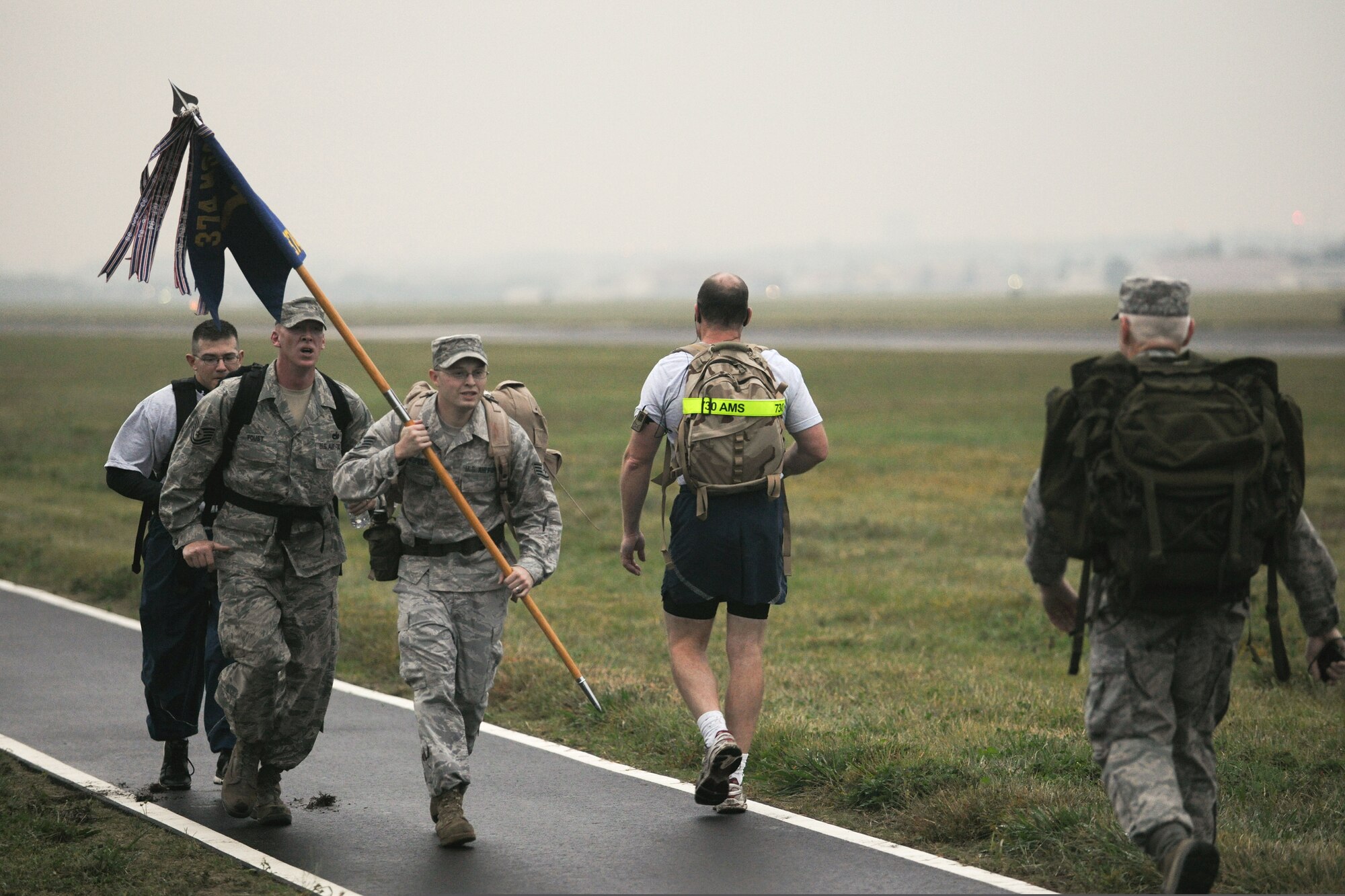YOKOTA AIR BASE, Japan -- Staff Sgt. Chase Neufeld, 374th Logistics Readiness Squadron, leads a ruck march with Squadron's guidon here Oct. 22 during the Fifth Air Force monthly ruck march.  (U.S. Air Force photo/Osakabe Yasuo) 