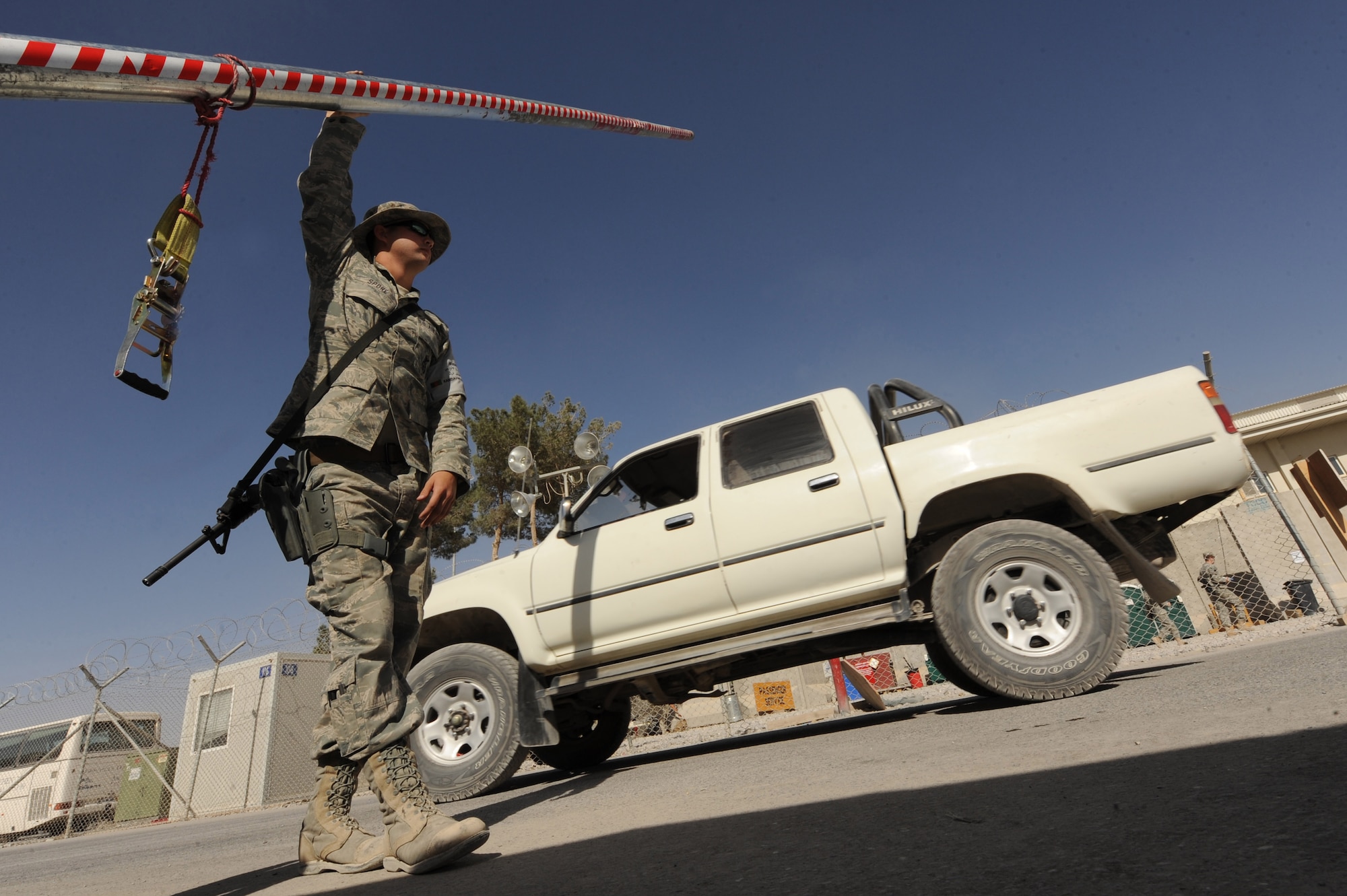 Airman 1st Class Chris Spore raises an entry control barrier for a crew to enter the flightline, Oct. 20, 2010, at Kandahar Airfield, Afghanistan.  Airman Spore, from Ocala, Fla., is a flightline security patrolman with the 451st Expeditionary Security Forces Squadron.  (U.S. Air Force photo by Tech. Sgt. Chad Chisholm/Released)   