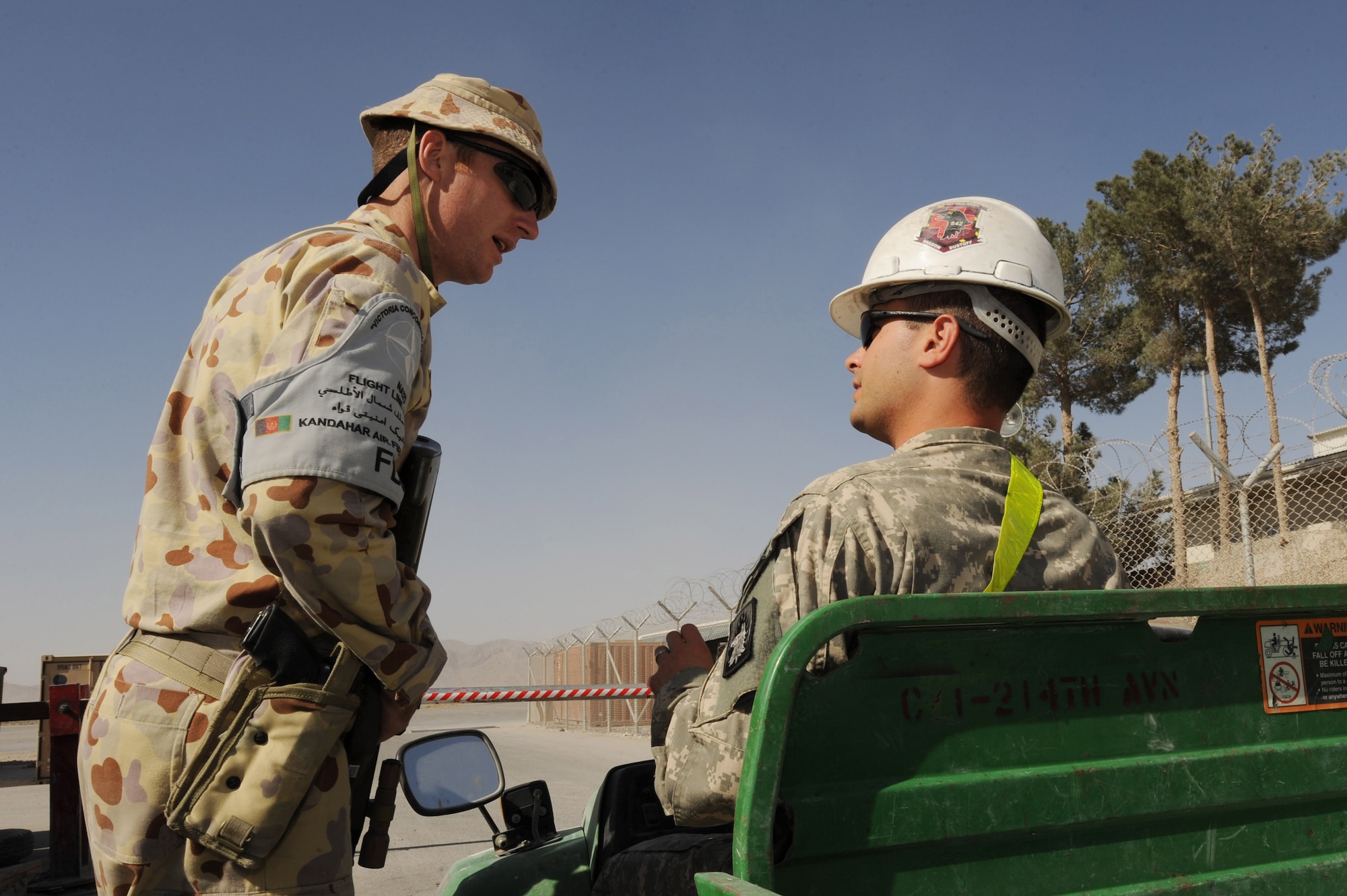 Royal Australian Air Force Leading Aircraftsman Steve Watson asks a U.S. Army Soldier for identification before granting him access to the flightline Oct. 20, 2010, at Kandahar Airfield, Afghanistan. Aircraftsman Watson is a Commander of Kandahar Airfield Flightline Security patrolman.  (U.S. Air Force photo by Tech. Sgt. Chad Chisholm/Released)