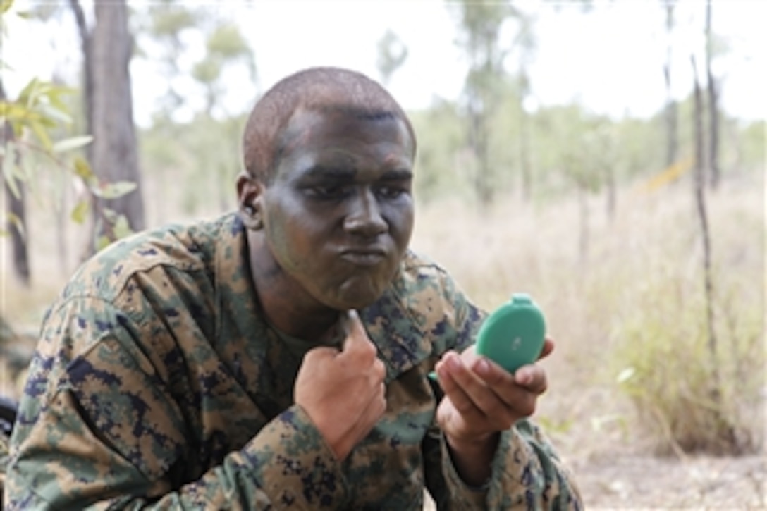 U.S. Marine Corps Lance Cpl. Michael Ellmer, assigned to Alpha Company, 1st Battalion, 3rd Marine Regiment, applies camouflage paint during Exercise Hamel 2010 at the Townsville Training Area, Australia, on Oct. 12, 2010.  U.S. Marines from the 3rd Marine Regiment are supporting Exercise Hamel, which is an annual exercise designed to enhance the Australian Army’s ability to fight and operate in a modern, complex battle space.  The exercise involves more than 6000 personnel from the Australian Defense Force.  