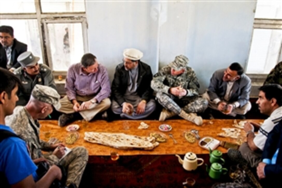 U.S. Army Gen. David H. Petraeus, commander of NATO and International Security Assistance Force troops in Afghanistan, tours a bazaar with U.S. Ambassador to Afghanistan Karl Eikenberry and Mohammed Fidai, Wardak provincial governor, in Mayden Shar, Afghanistan, Oct. 21, 2010.